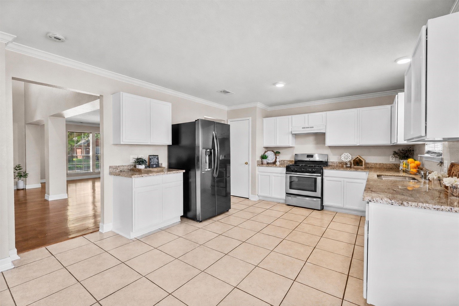 Spacious kitchen featuring abundant cabinet storage, generous counter space, gas cooking, and a functional layout that flows seamlessly into the living areas.