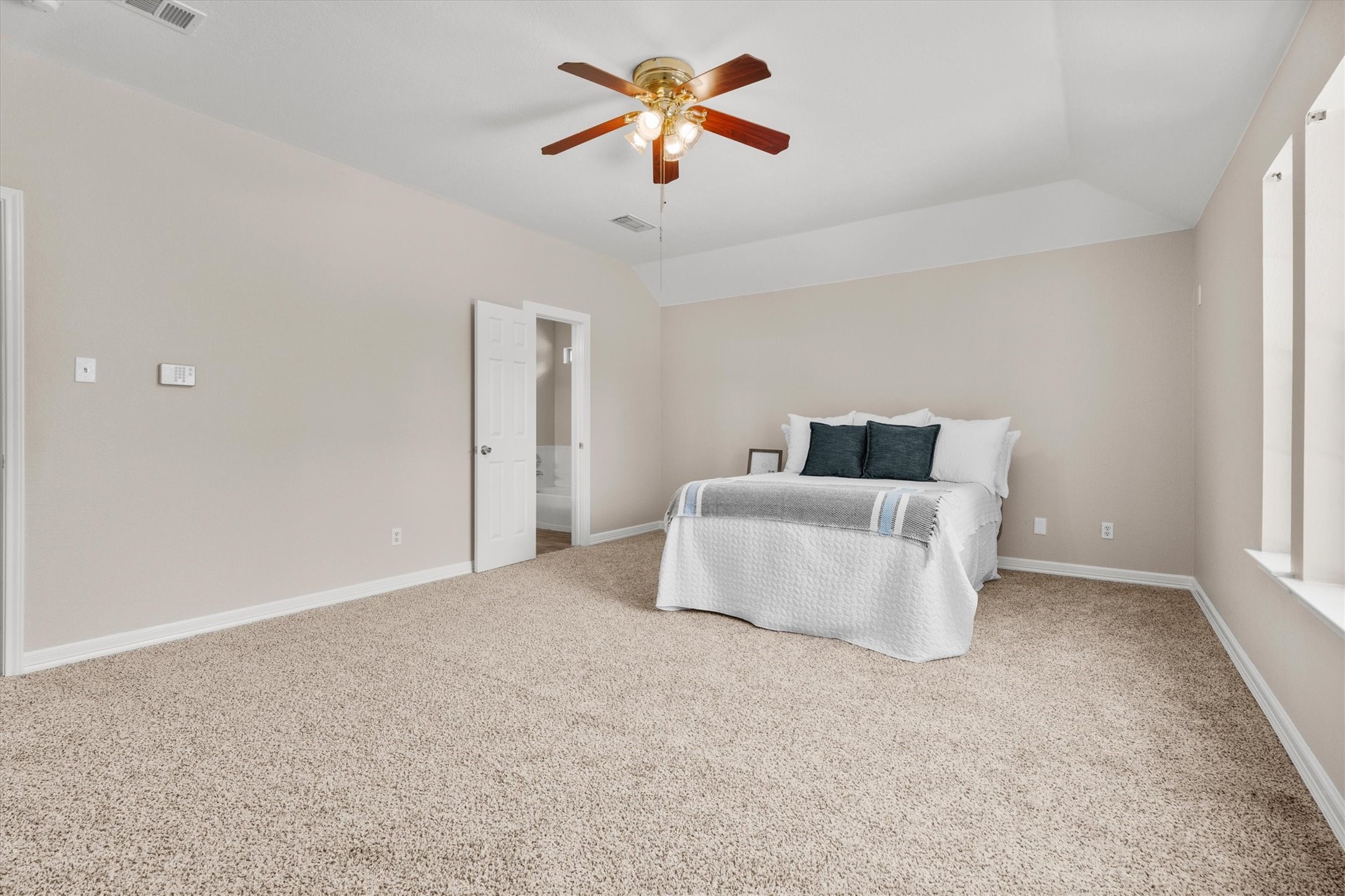 Generous primary retreat with plenty of space for oversized furniture and an ensuite bath.