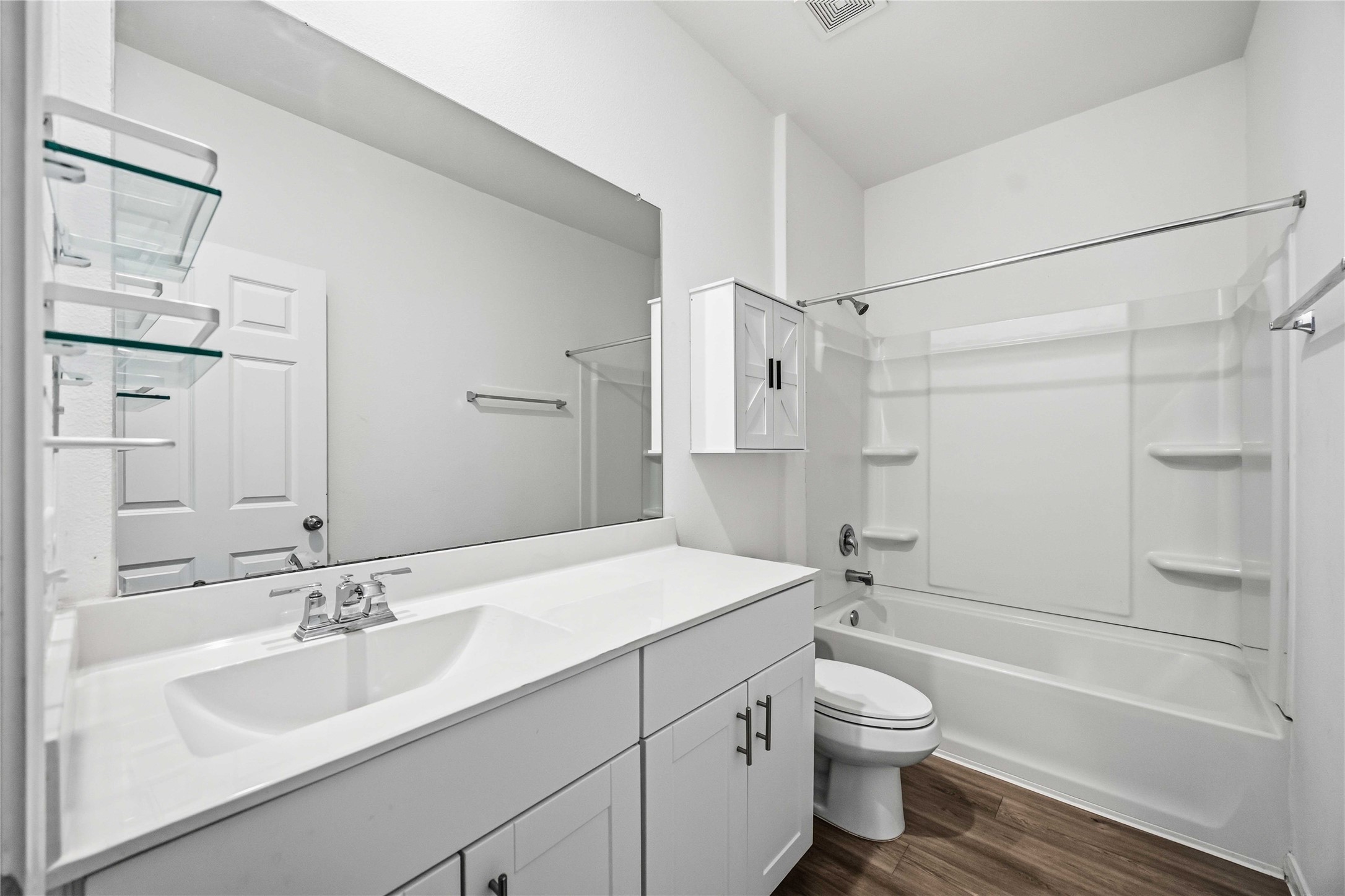 Secondary bathroom with a tub/shower combination and vanity storage.