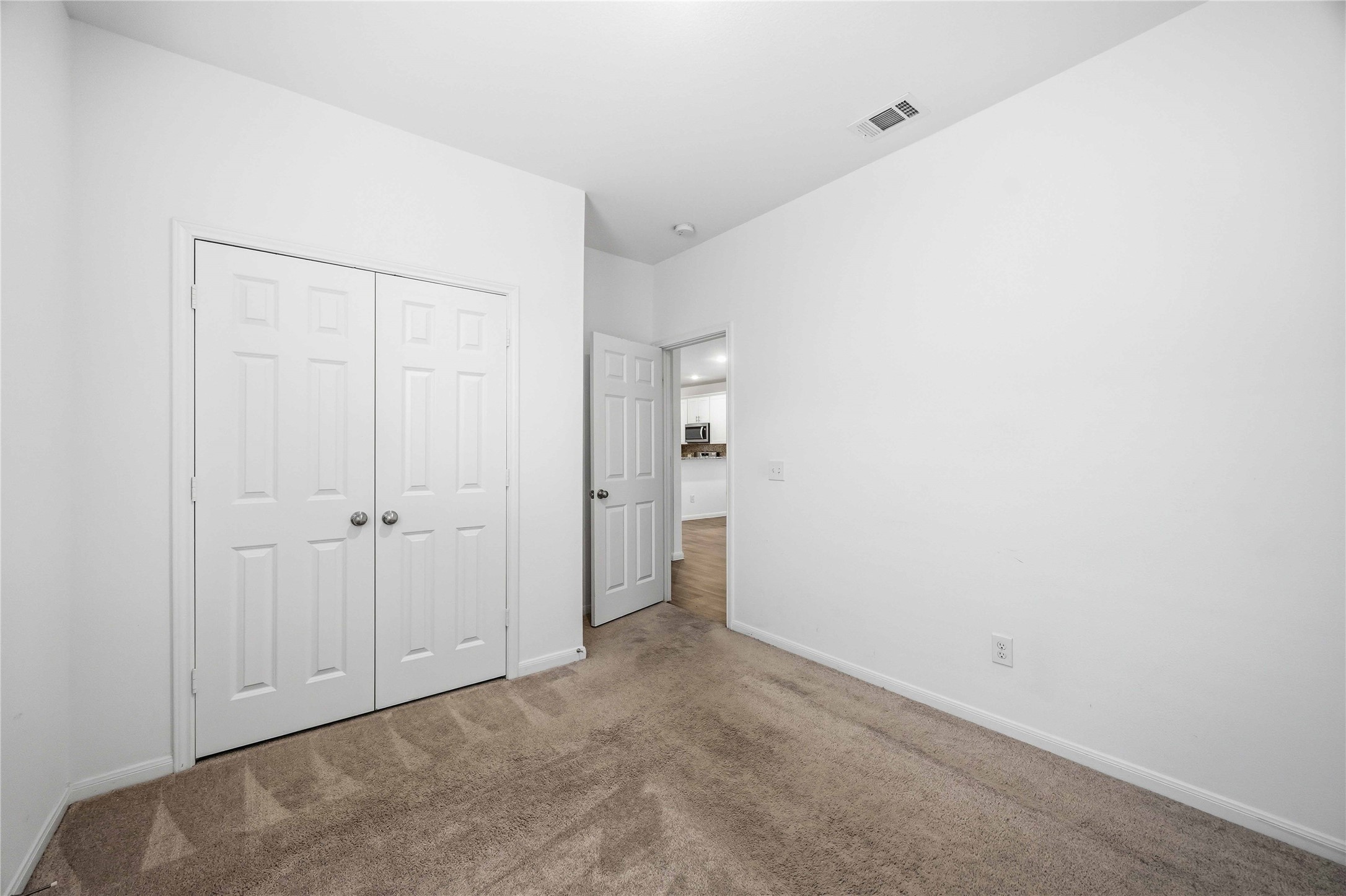Secondary bedroom featuring a double-door closet.