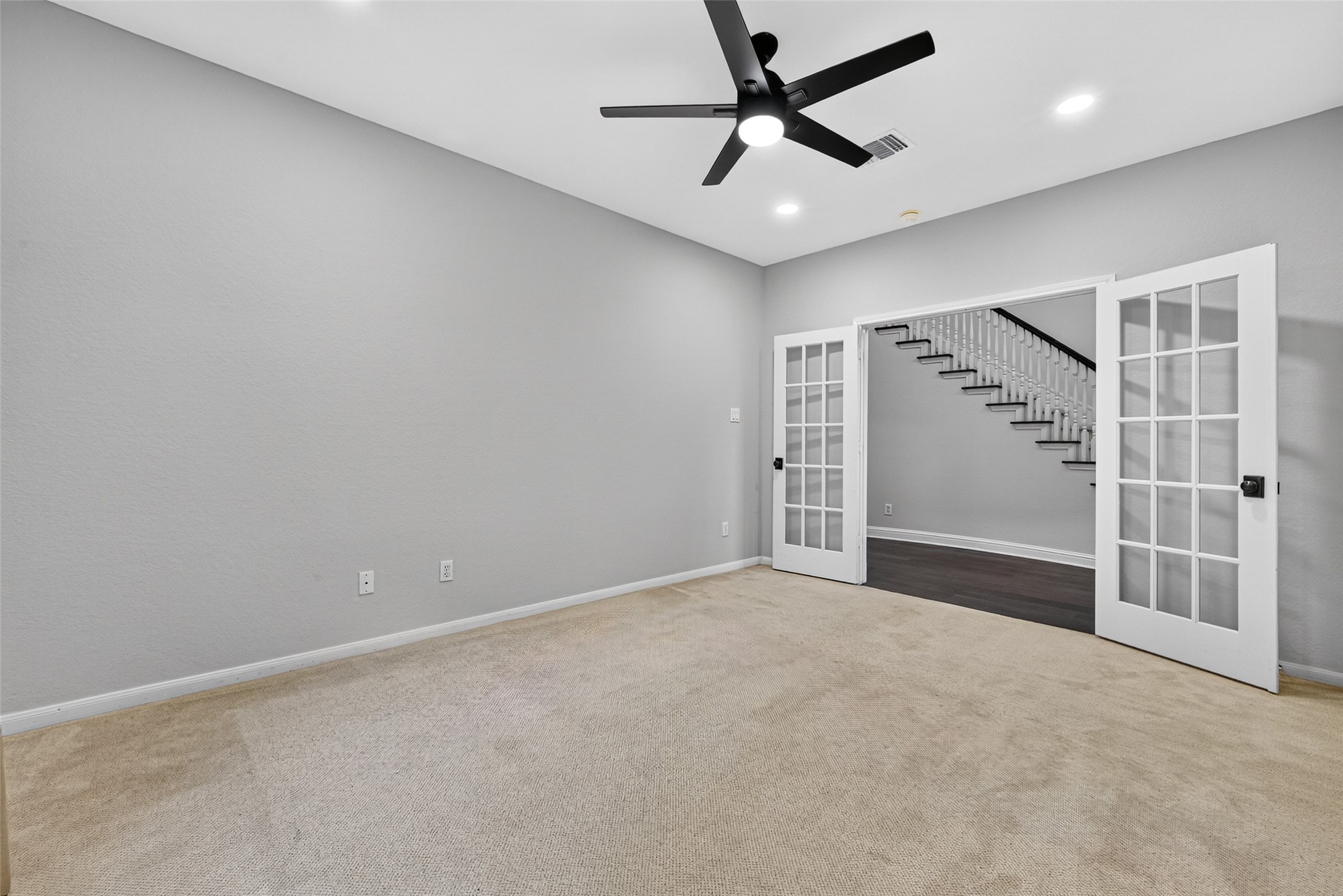 A ROOM WITH SO MANY POSSIBILITIES! Located on the first floor, this spacious Study features French doors, a ceiling fan with light, recessed lighting & neutral finishes. Whether you're looking for a private home office, a comfortable guest bedroom, a quiet reading retreat or an additional television room, this versatile space can easily adapt to your needs. With a full bath conveniently located nearby, it also offers the flexibility to serve as Bedroom #4.
