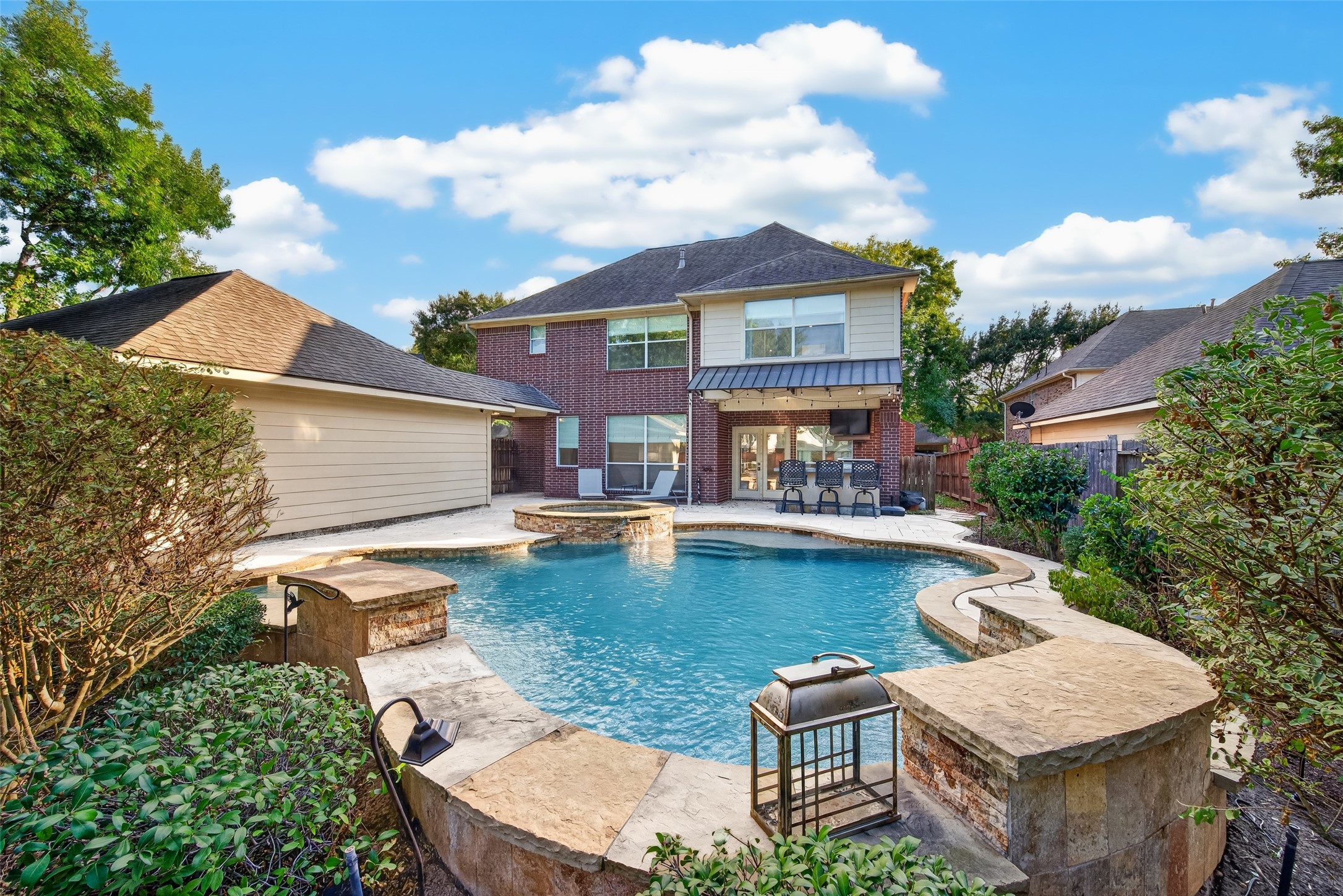 A BACKYARD WORTH COMING HOME TO! Looking back toward the home, you can appreciate how beautifully the pool, spa, outdoor kitchen & generous patio areas come together. French doors connect the indoor living spaces to this inviting outdoor retreat. From morning coffee beside the pool to evenings spent entertaining under the stars, there's so much to enjoy here.