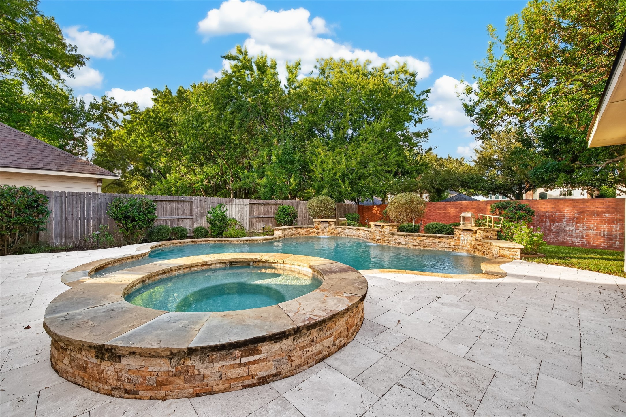 RELAX, UNWIND & STAY AWHILE! Imagine sinking into the heated spa after a long day, listening to the gentle sound of cascading waterfalls and enjoying the peaceful backyard surroundings. The beautiful stonework, curved pool design & lush landscaping create a private resort-like atmosphere right at home.