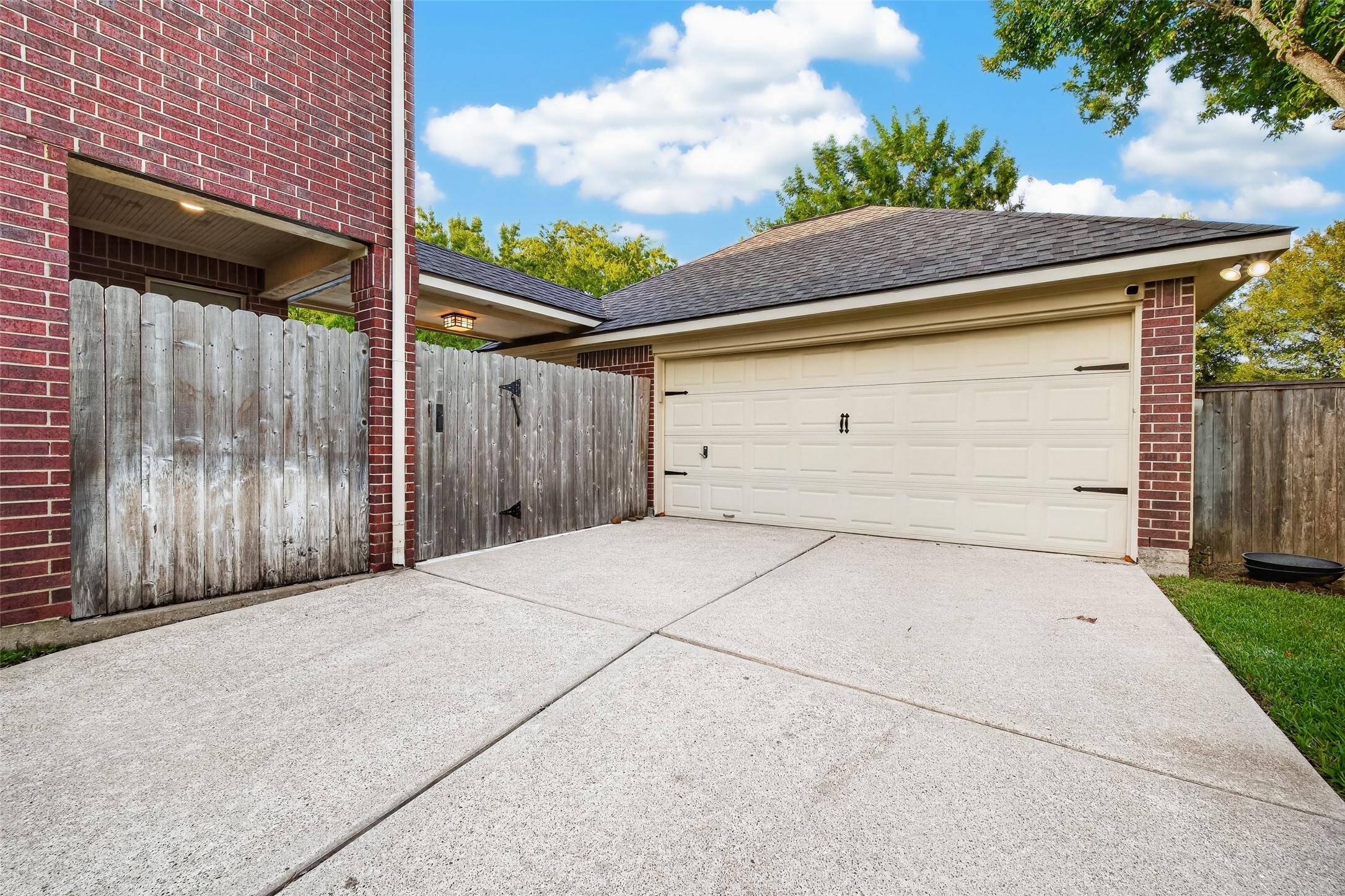 AN OVERSIZED DETACHED GARAGE! The detached 2-car garage offers plenty of room for parking, while the wide concrete driveway provides additional space. A covered breezeway connects the house & garage, keeping you sheltered from the rain as you come & goa welcome convenience during those Houston downpours! Gated access also provides a convenient connection to the backyard.