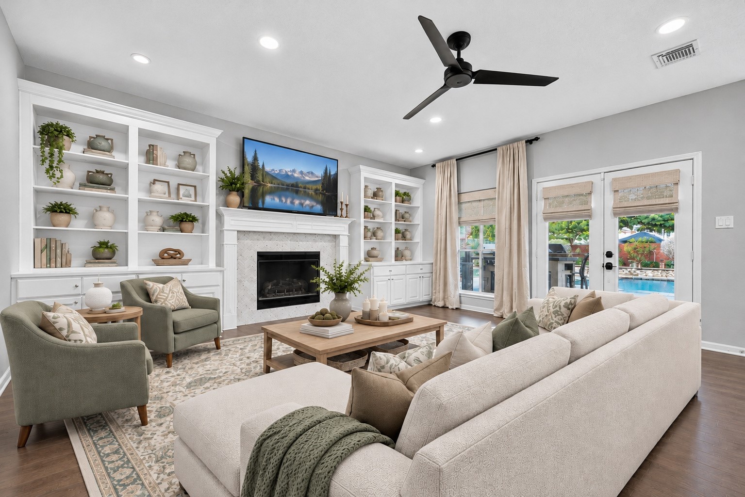 VIRTUALLY STAGED TO INSPIRE! Imagine settling into a comfortable sofa after a long day, enjoying conversation around the coffee table or curling up with a favorite book beside the fireplace. This virtually staged photograph illustrates how beautifully the Family Room accommodates a generous seating arrangement, with room for accent chairs & the built-in shelves providing the perfect backdrop for your favorite decorative pieces.