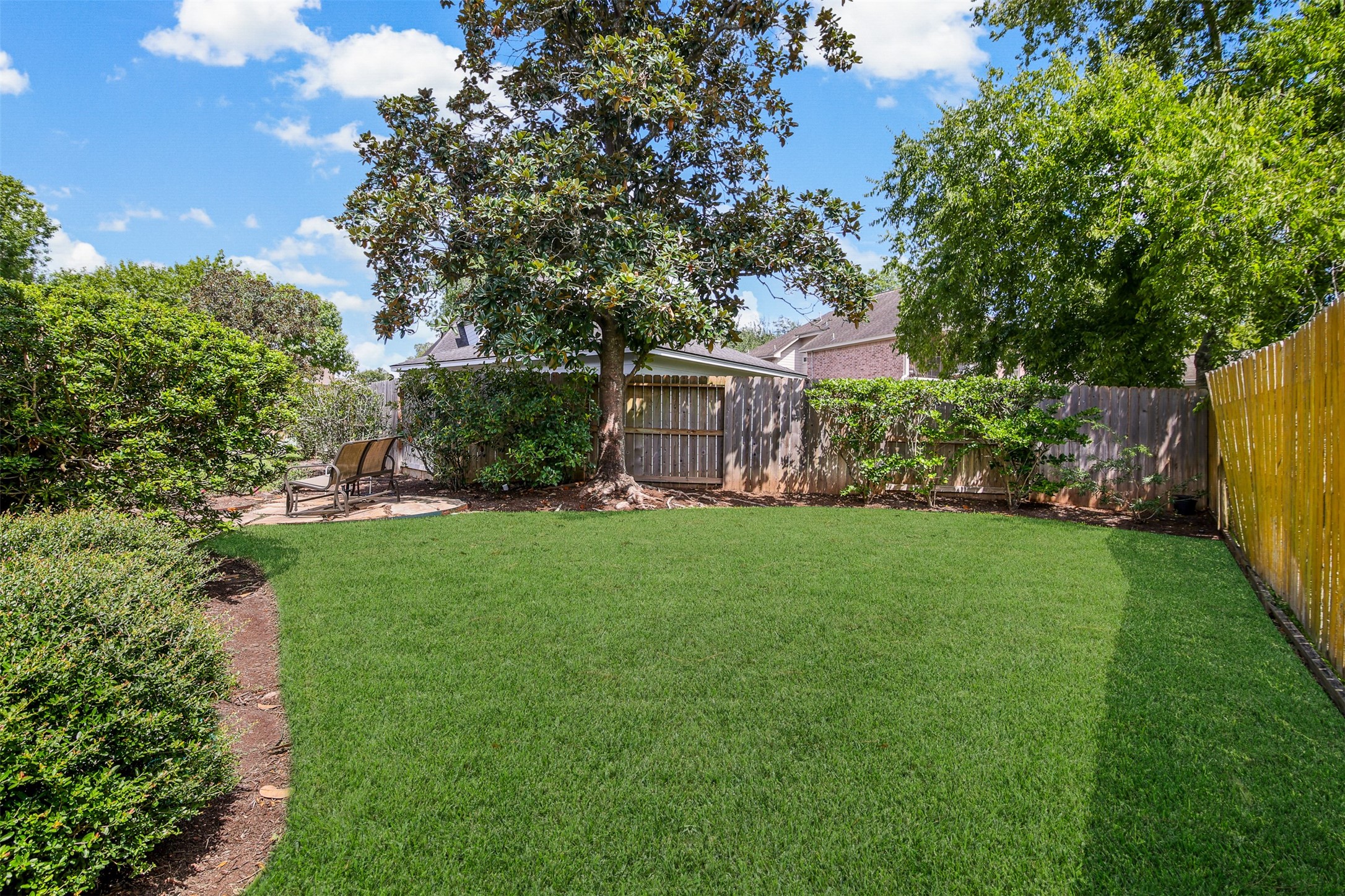 Another view of the backyard with plenty of green space for the kids and pets to play. *Grass has been virtually enhanced*