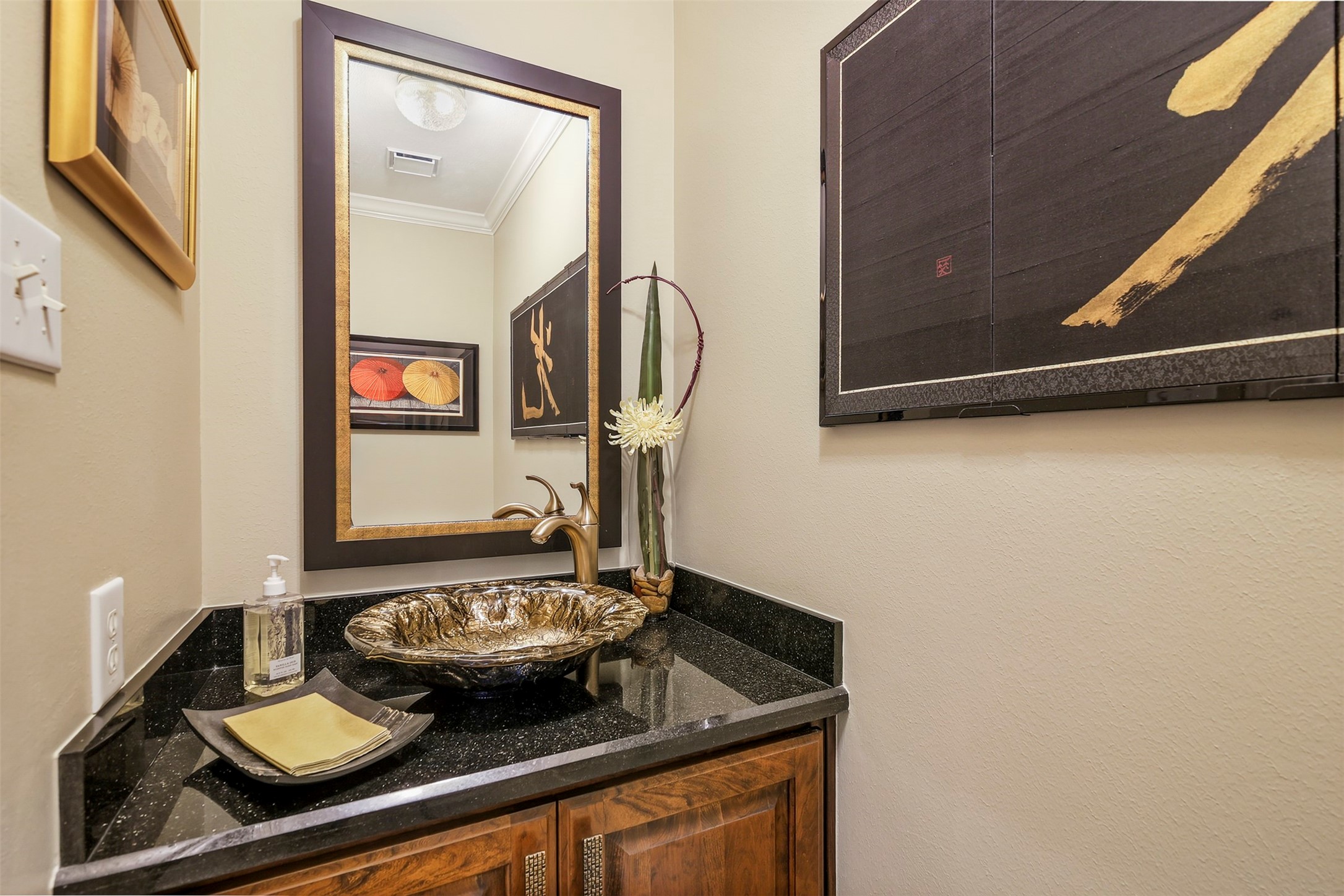 Half bathroom downstairs with custom sink and vanity.