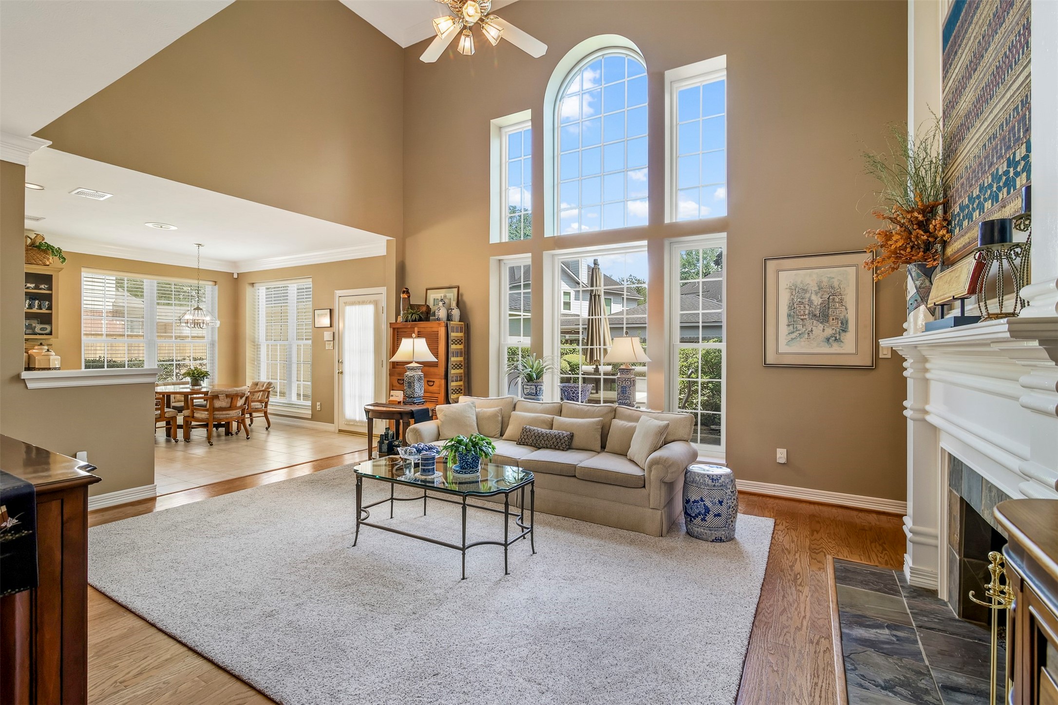 Another view of the family room with two story windows for an abundance of natural light.