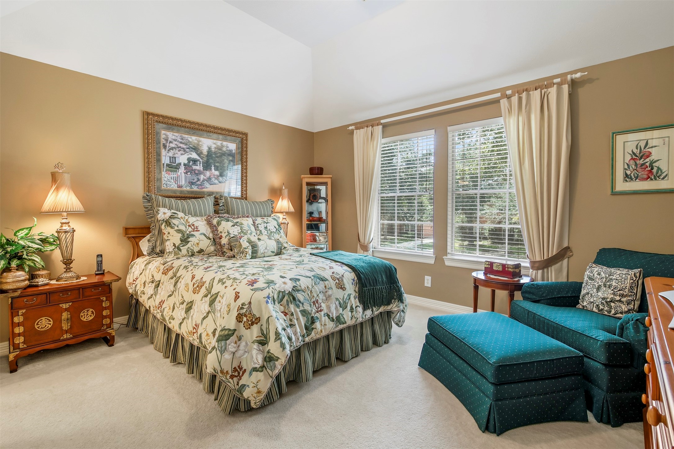 Additional secondary bedroom upstairs with carpet, elevated ceiling and large picture windows. This room has access to a shared ensuite bathroom.