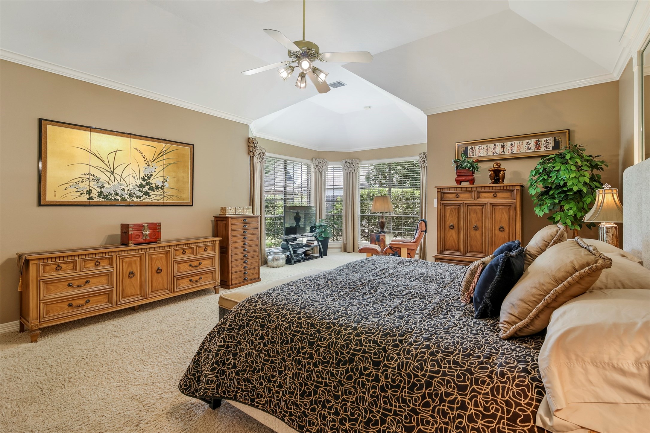 Another secondary bedroom with carpet and large picture window as well as access to ensuite shared bathroom.