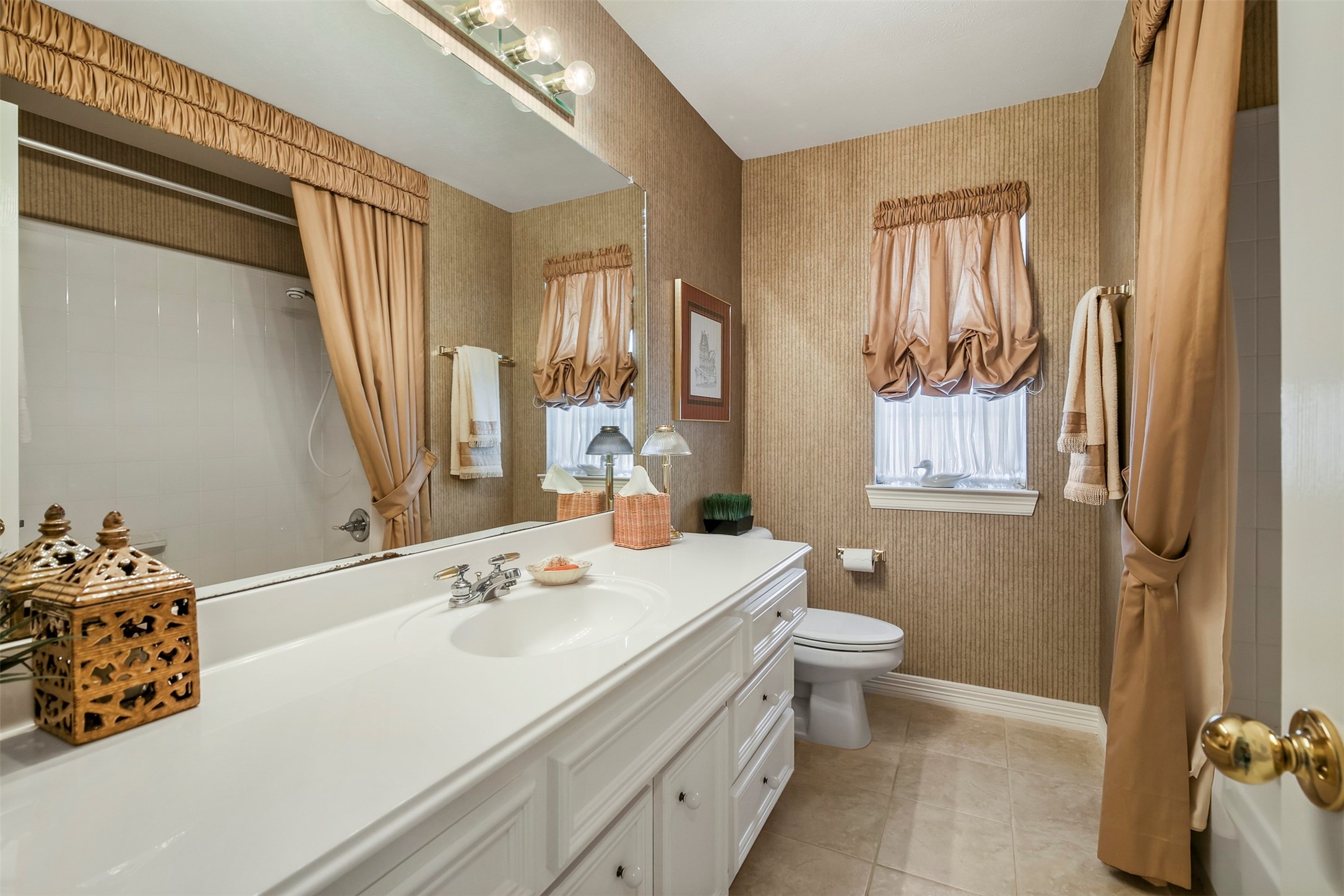 Another secondary full bathroom upstairs with single sink and tub/shower combo.