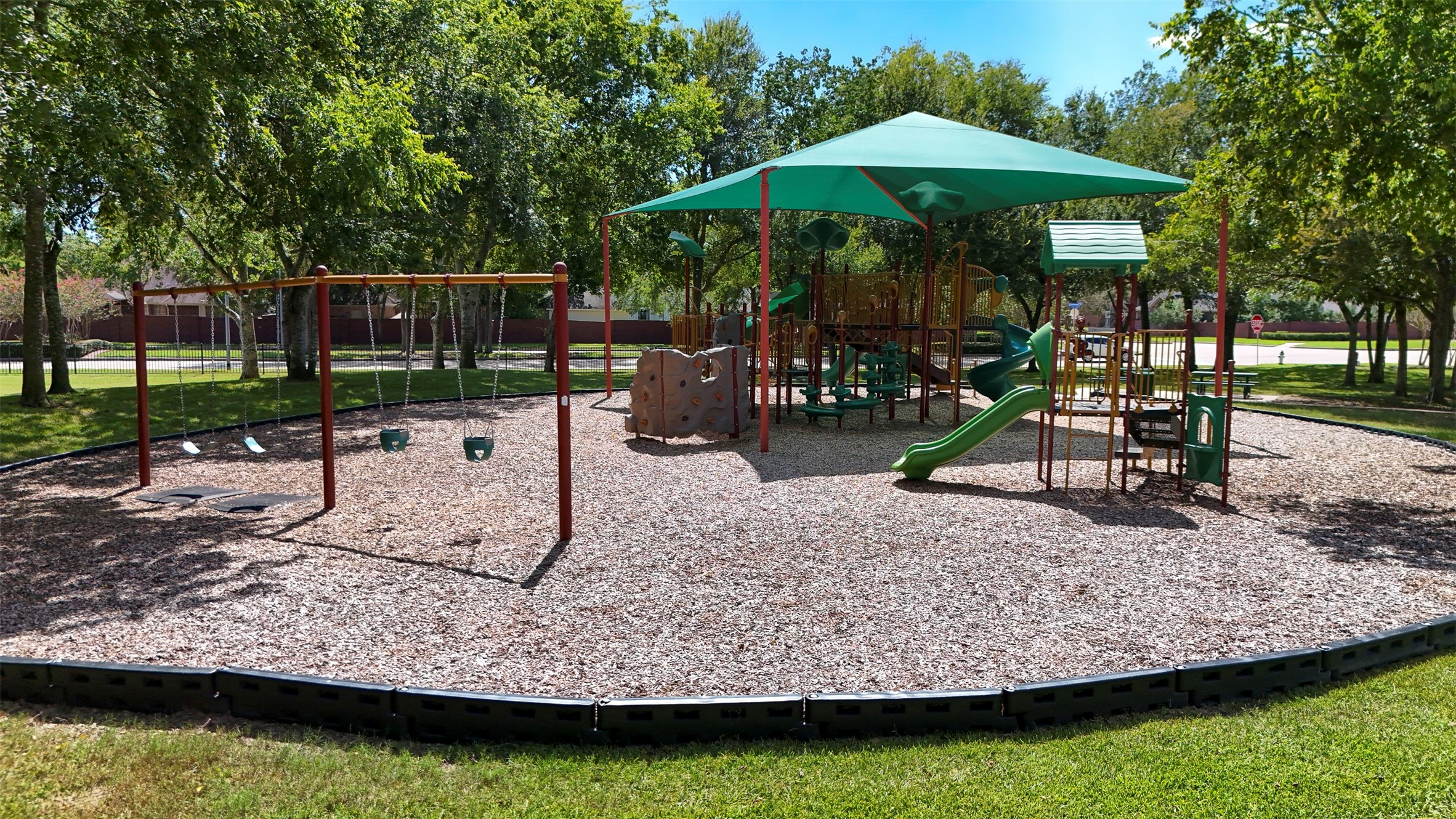 Neighborhood playground with shade covering.