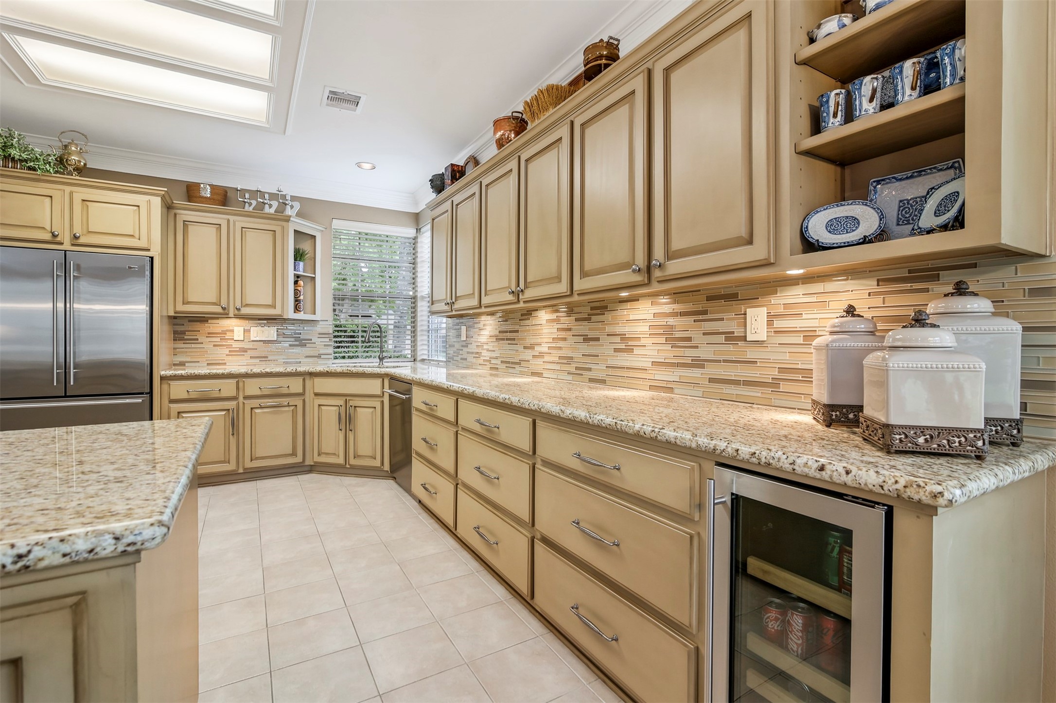 Another view of the kitchen with exposed custom shelving at the ends of the cabinets.