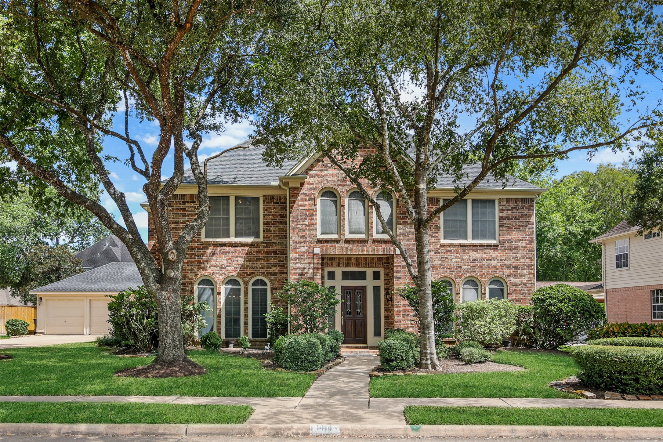 Charming two-story home with lots of custom details in the master planned community of Greatwood. *Grass virtually enhanced*
