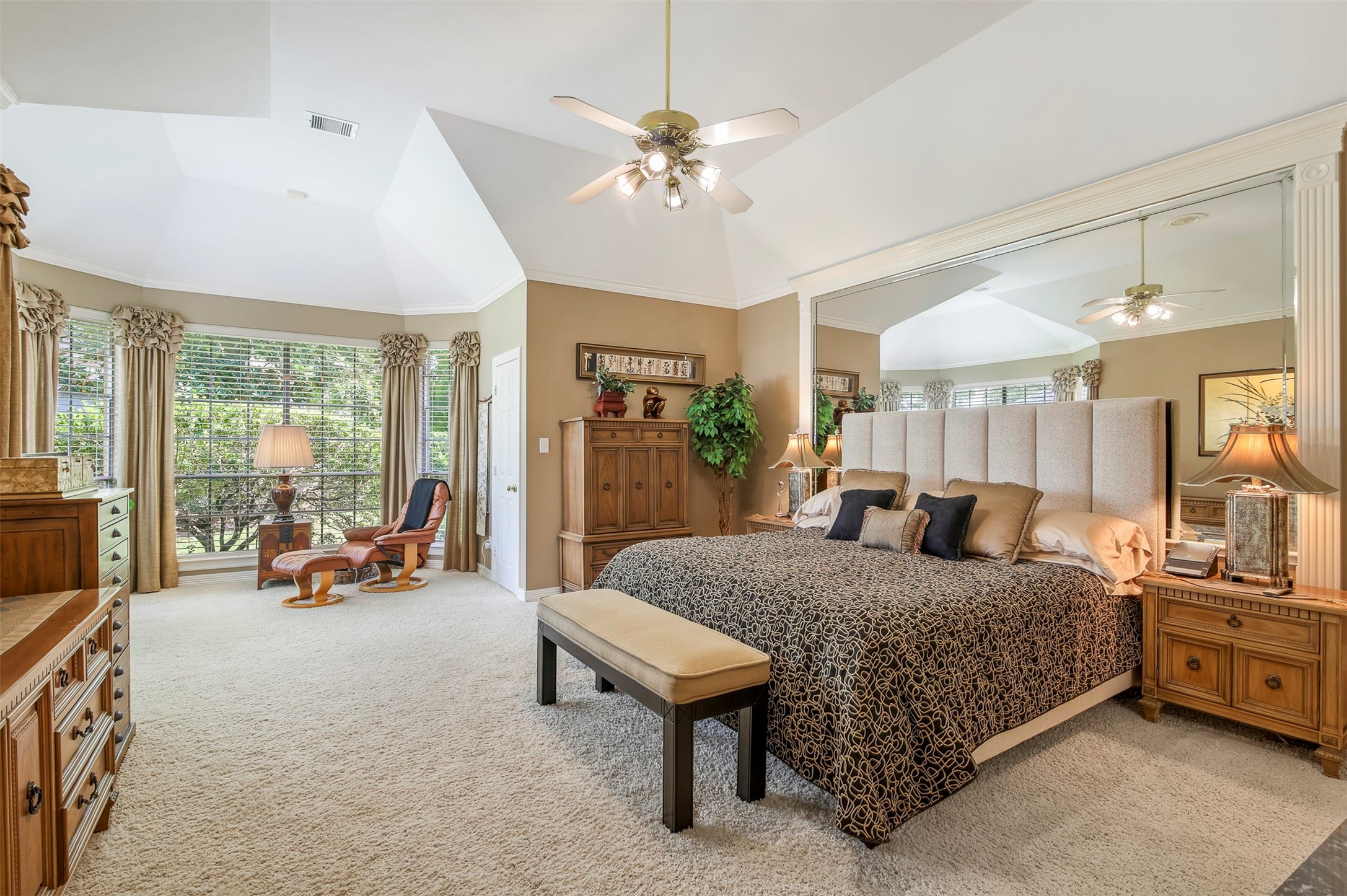 The primary bedroom is your own private retreat with separate sitting room area, elevated ceilings, fan and plush carpet.