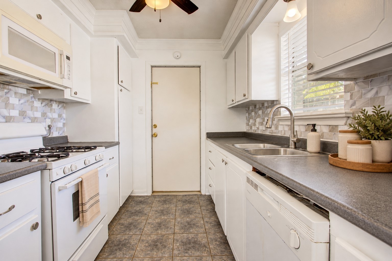 As you go past the dining room, you enter the lovely and bright kitchen
