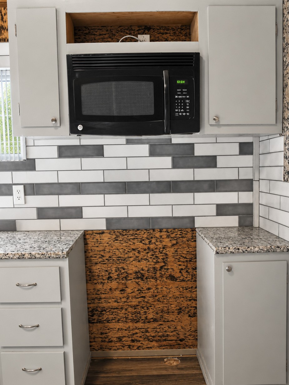 Addition kitchen nook featuring a modern black microwave.