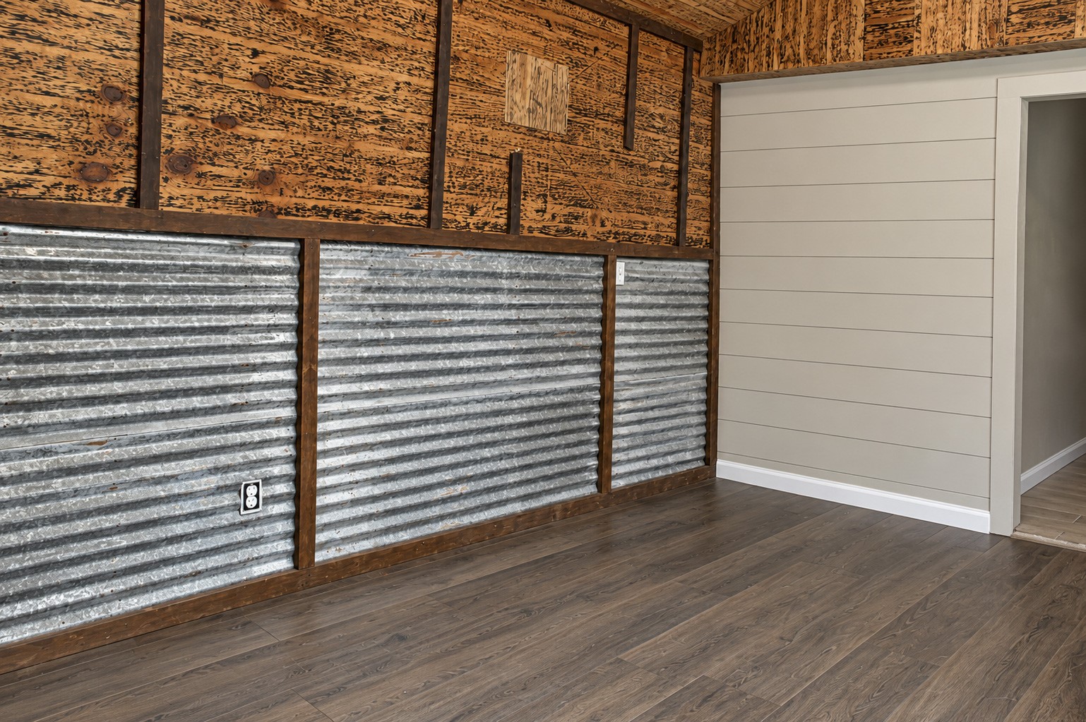 Charming rustic additional kitchen with corrugated metal and wood paneling.