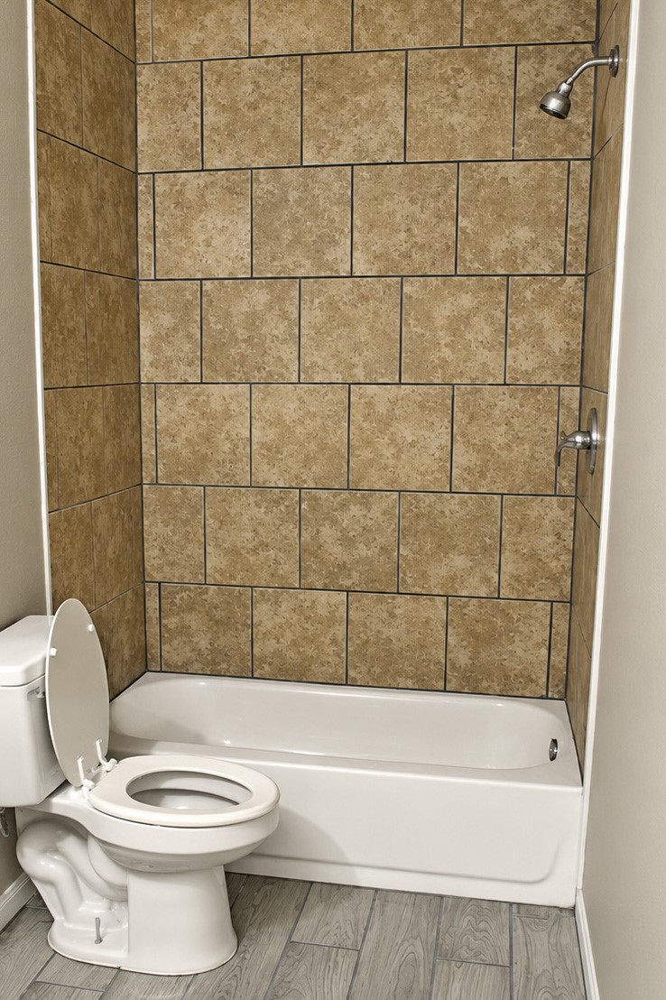Bathroom features a tiled shower and tub combination, complemented by neutral-toned walls.