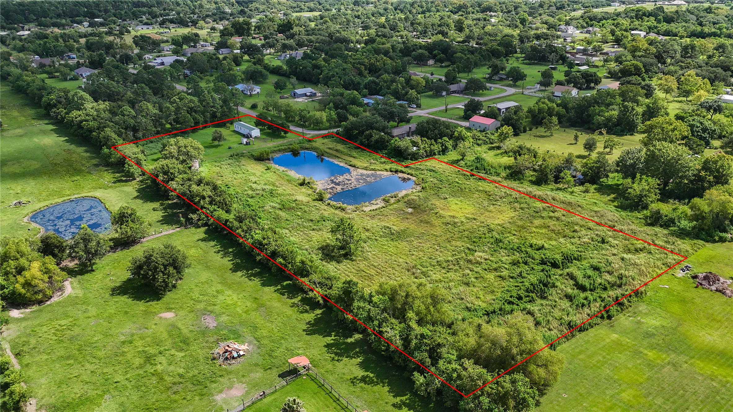 Expansive property with a delineated boundary, featuring a serene pond and lush greenery, offering ample space for outdoor activities and relaxation. Expansive property with a delineated boundary, featuring a serene pond and lush greenery, offering ample space for outdoor activities and relaxation.