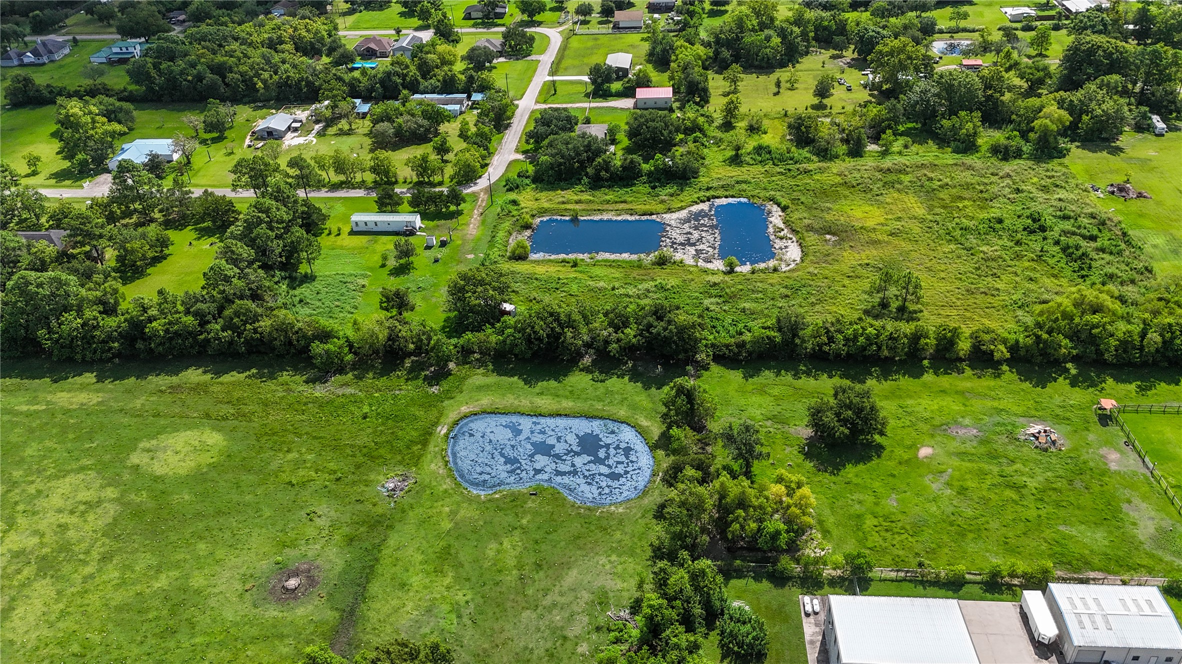 Expansive land featuring a serene pond, ideal for recreational activities, surrounded by lush greenery and offering a peaceful rural setting. Expansive land featuring a serene pond, ideal for recreational activities, surrounded by lush greenery and offering a peaceful rural setting.