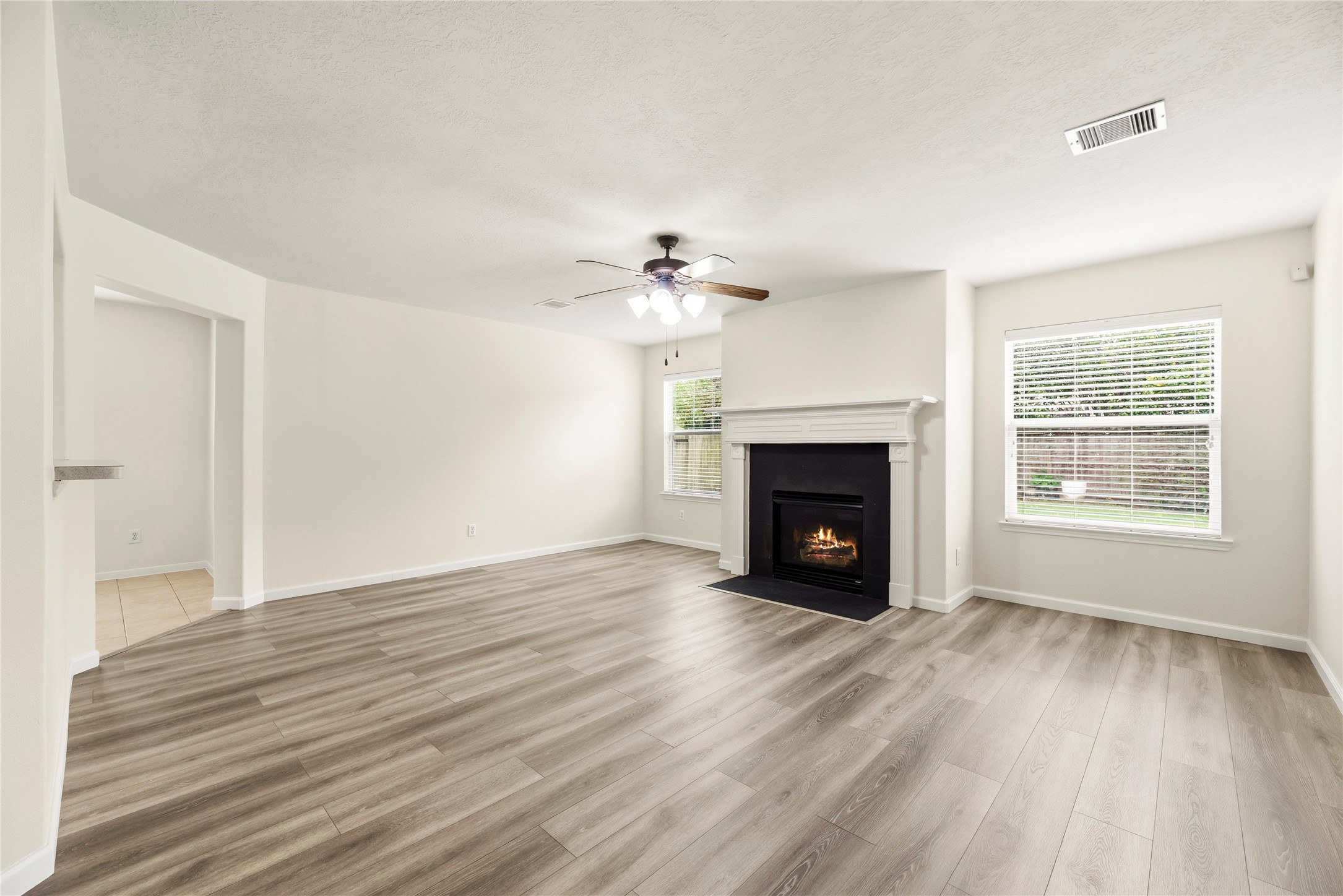 The family room offers LVP flooring and a gas log fireplace.