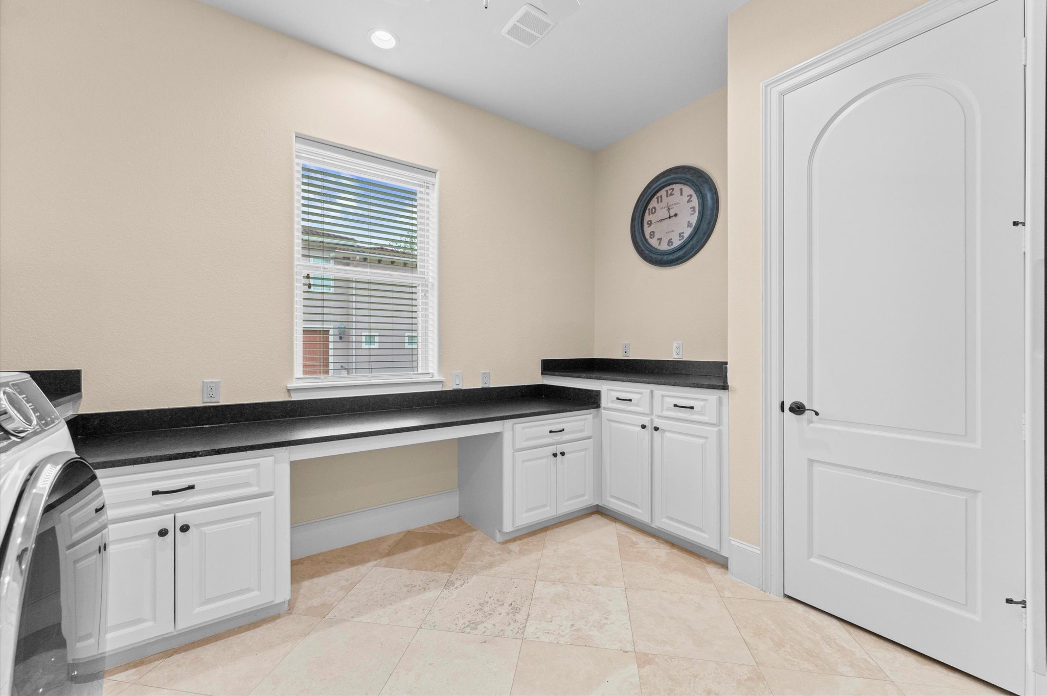 Laundry room has a closet large enough to store a decorated Christmas tree!