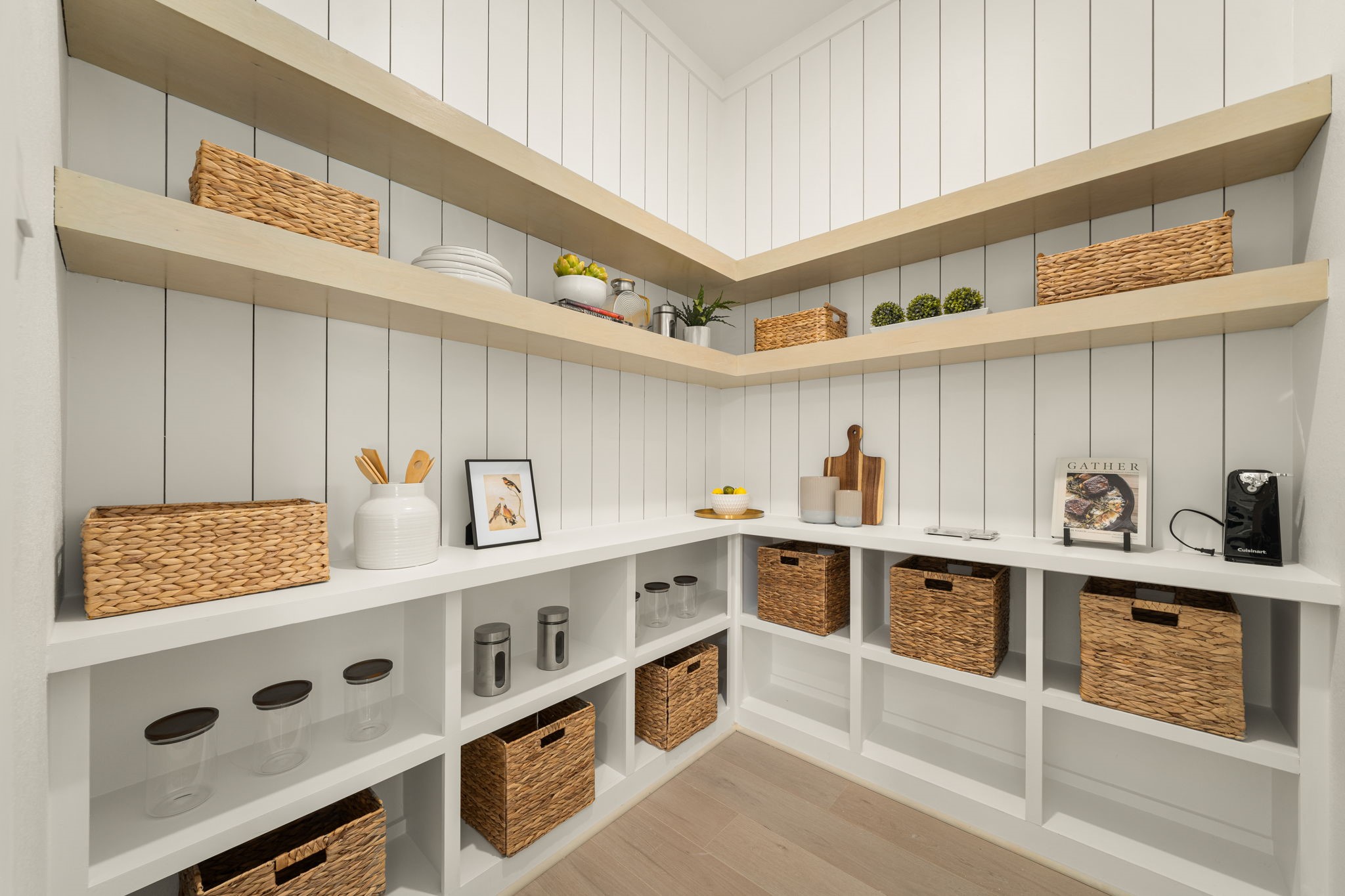 Exceptional walk-in pantry featuring extensive built-in shelving, cabinetry, and thoughtfully designed storage.