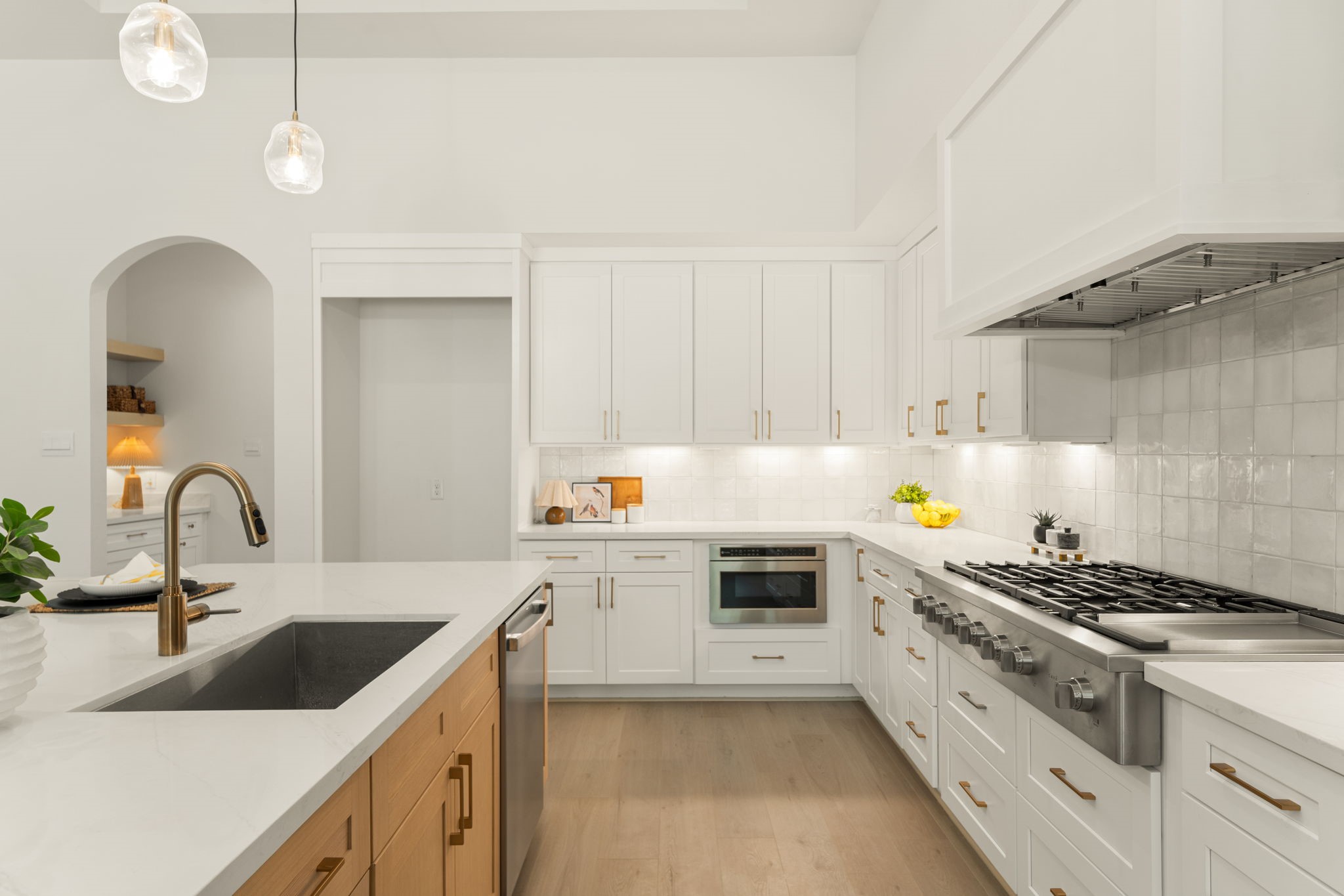 Stunning kitchen showcasing elegant countertops, custom cabinetry, and a gas cooktop.