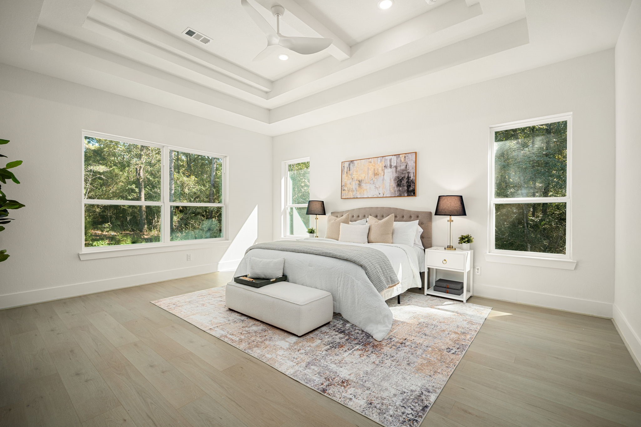 Luxurious primary bedroom featuring elegant ceiling details, generous proportions, and beautiful natural light.