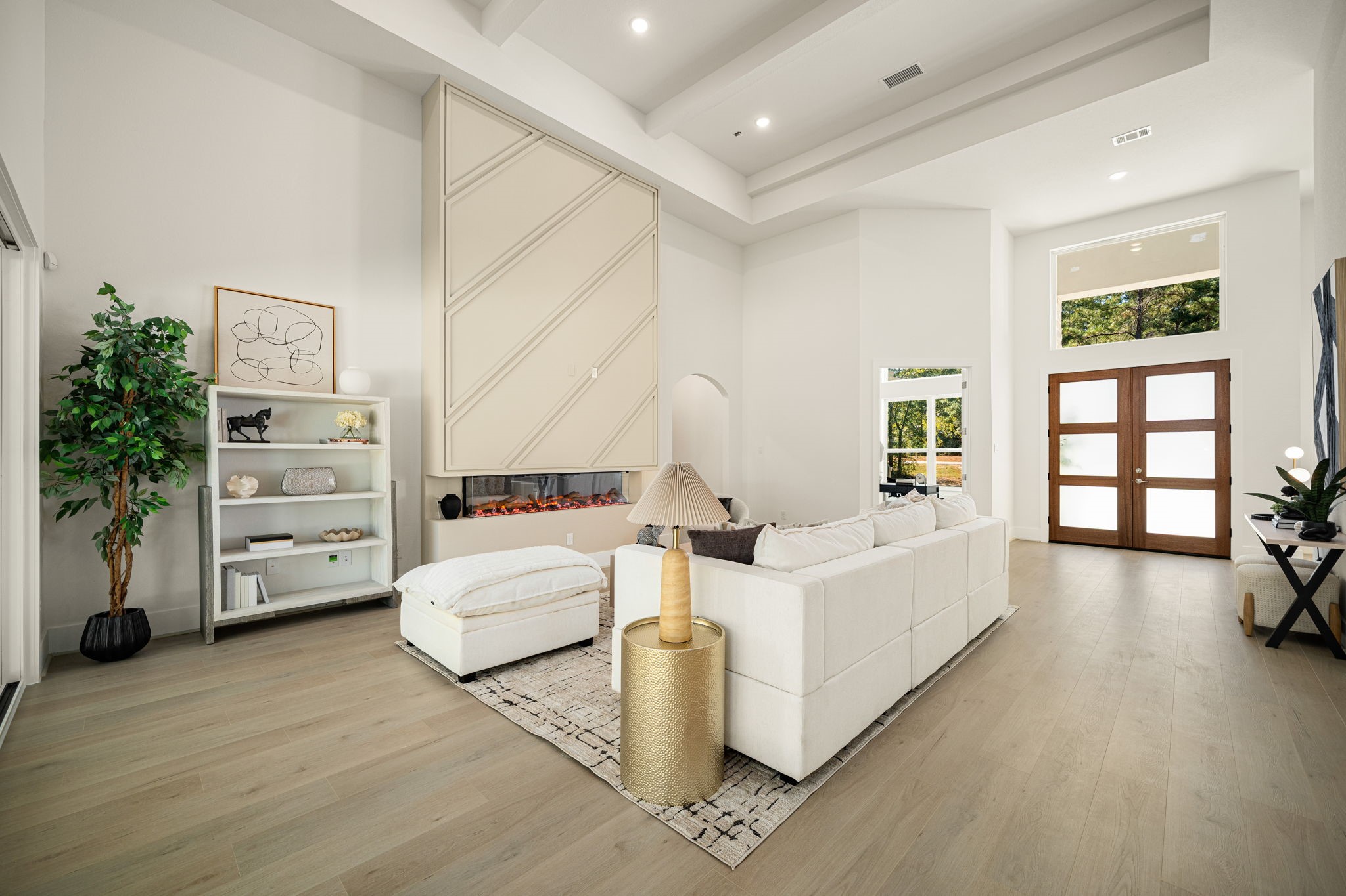 Beautifully designed living area featuring a sophisticated neutral palette, high ceilings, and abundant natural light.
