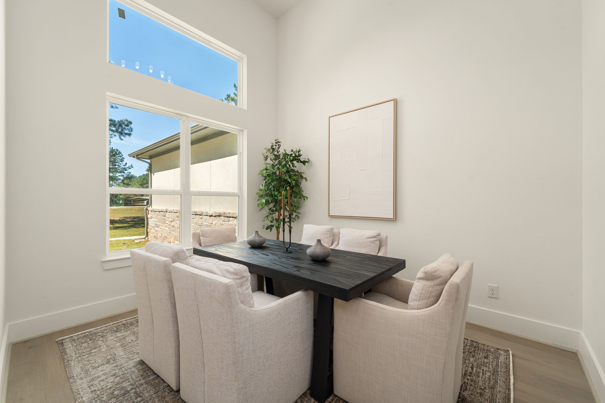Versatile dining room with large windows, abundant natural light, and an inviting atmosphere.