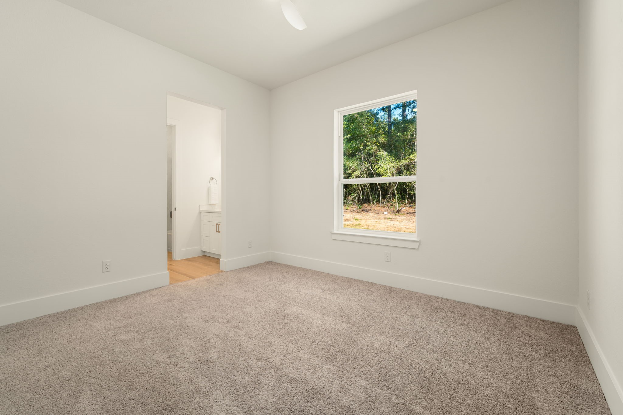 Comfortable secondary bedroom with neutral finishes and plenty of space to personalize.