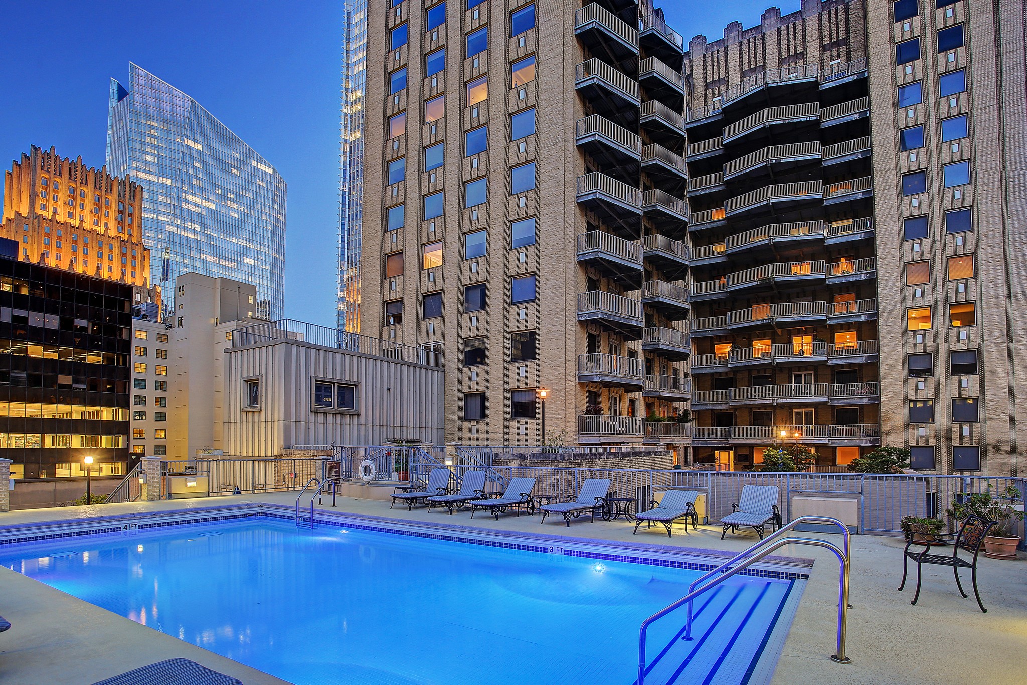 Enjoy the city skyline views from this stunning rooftop pool area, perfect for relaxing or entertaining.