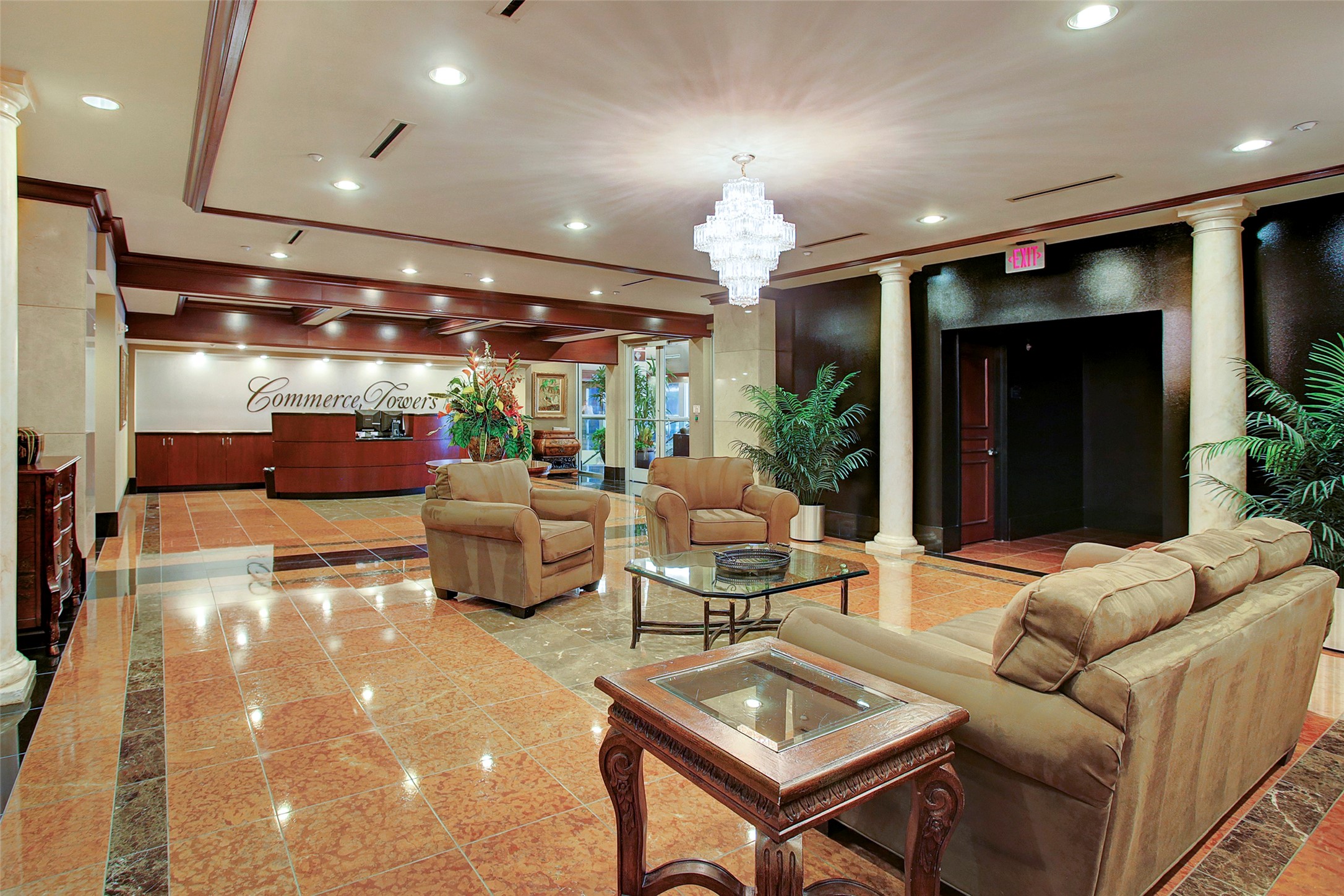 Elegant lobby with plush seating, marble floors, and a stunning chandelier, providing a luxurious and welcoming atmosphere.