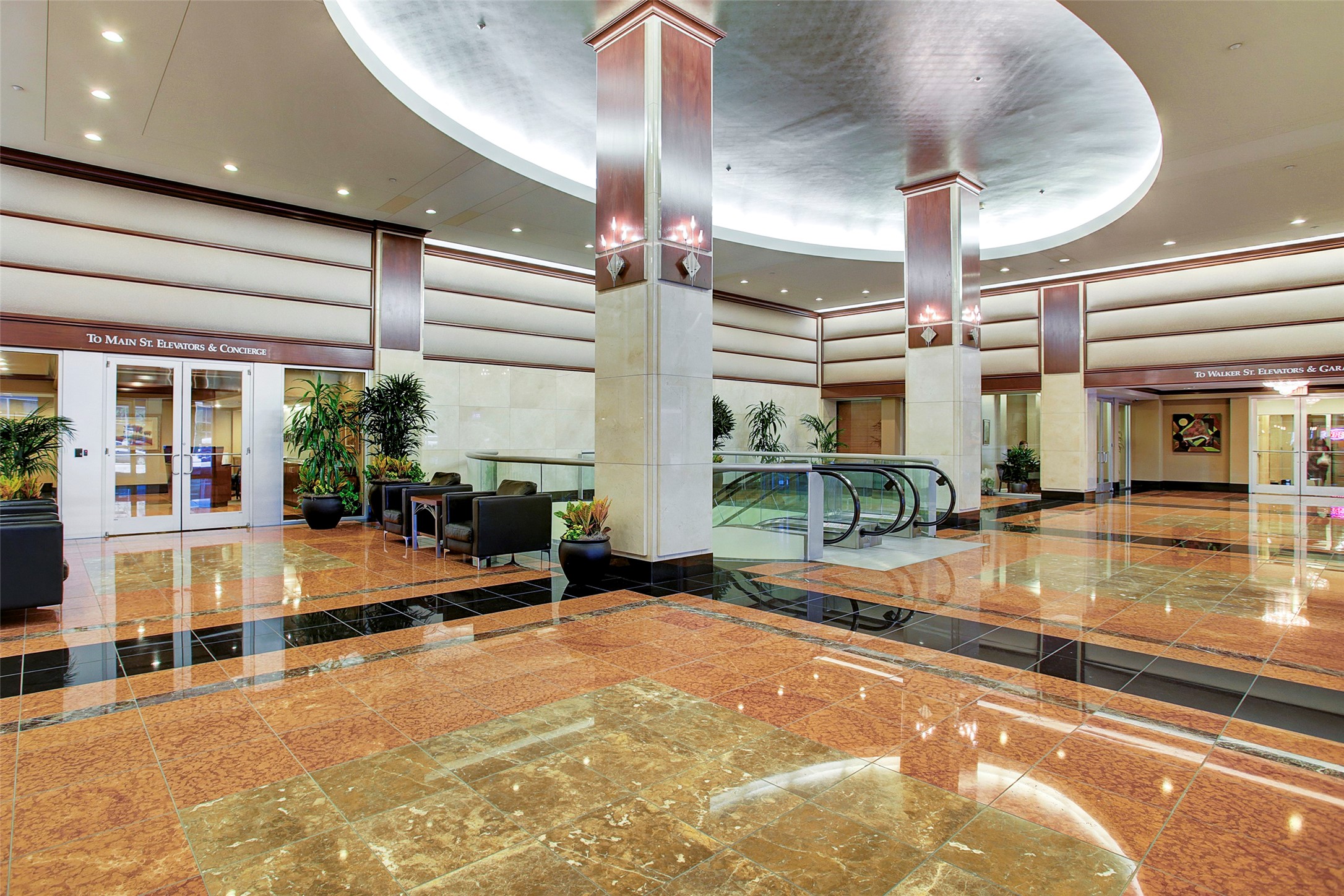 Elegant and spacious lobby with polished marble floors, modern lighting, and comfortable seating areas, perfect for welcoming guests.