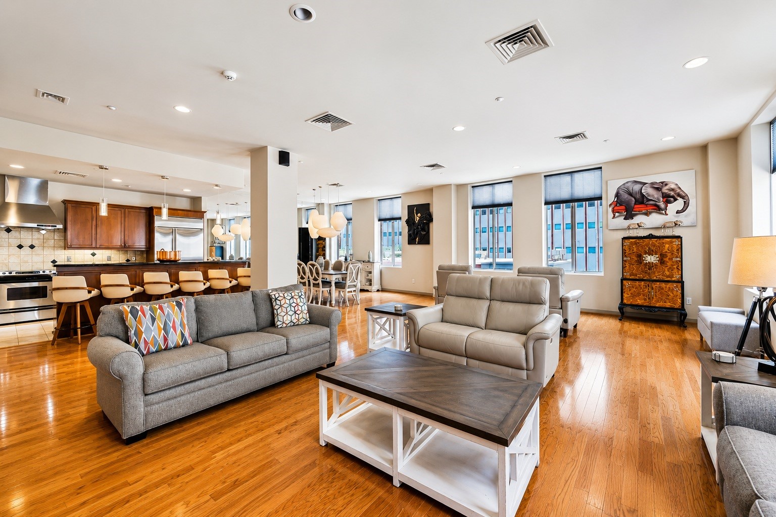 Welcome to Commerce Towers 801 corner unit, 2 bedroom 2 bathroom, plenty of closet space, 2 assigned parking spaces, 24/7 valet, direct downtown tunnel access. Living room featuring abundant natural light from multiple windows, beautiful hardwood floors, and an open layout ideal for relaxing and entertaining.