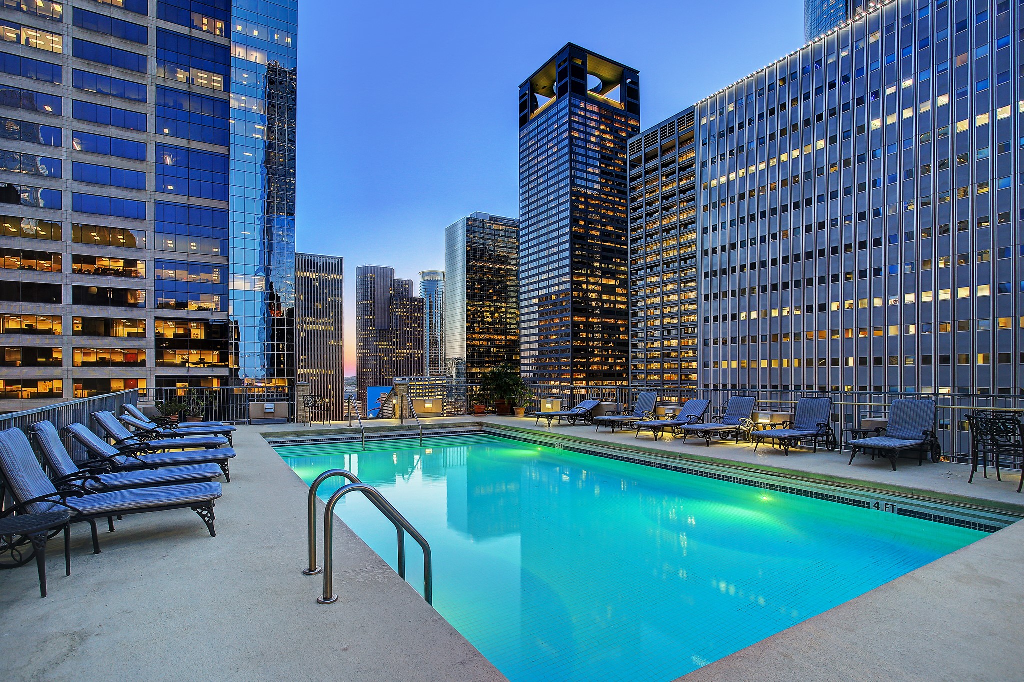 Experience urban luxury with this stunning rooftop pool, surrounded by the vibrant skyline, offering a perfect retreat in the heart of the city.
