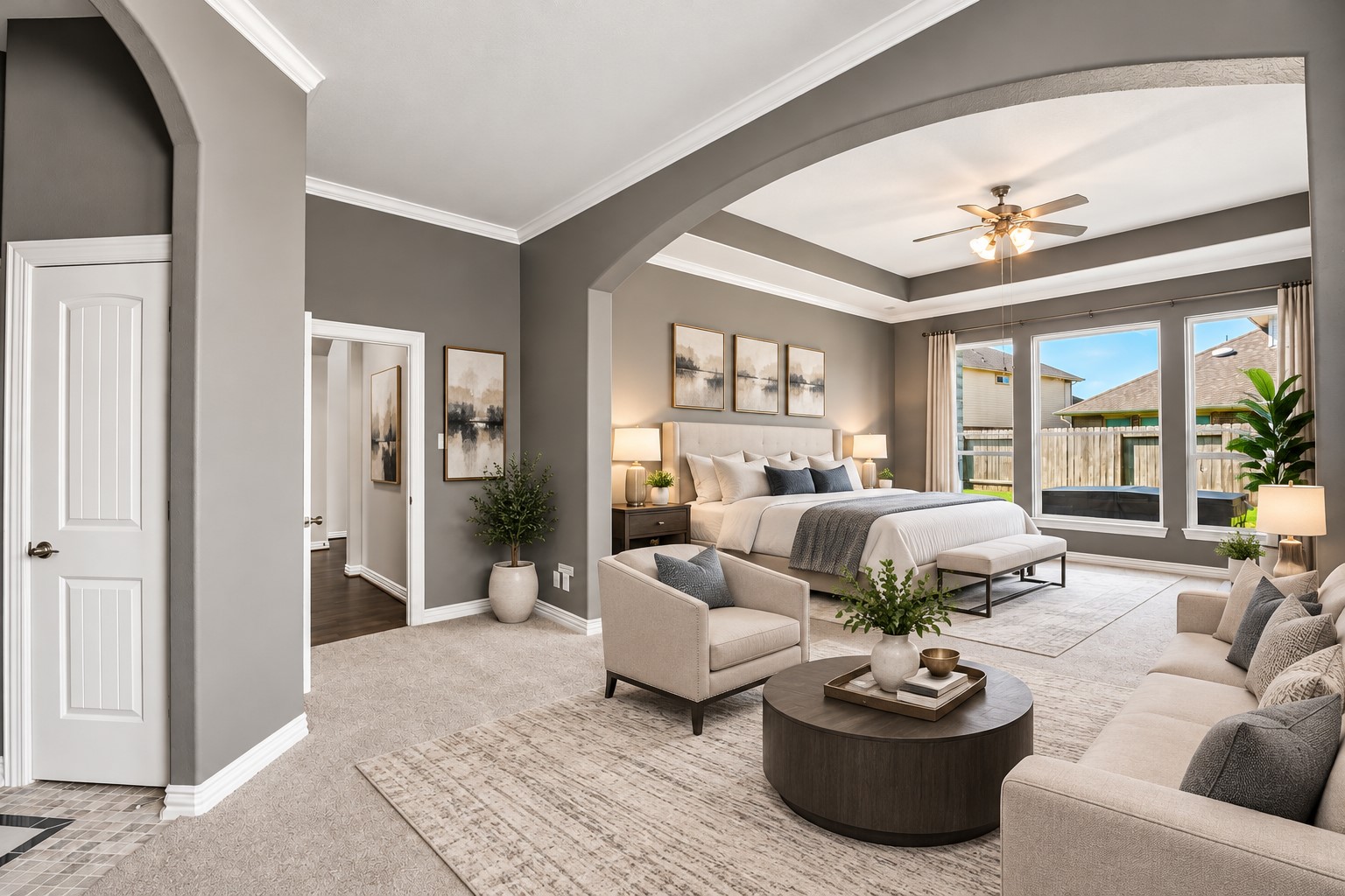 Sitting room with primary suite in background (virtually staged)