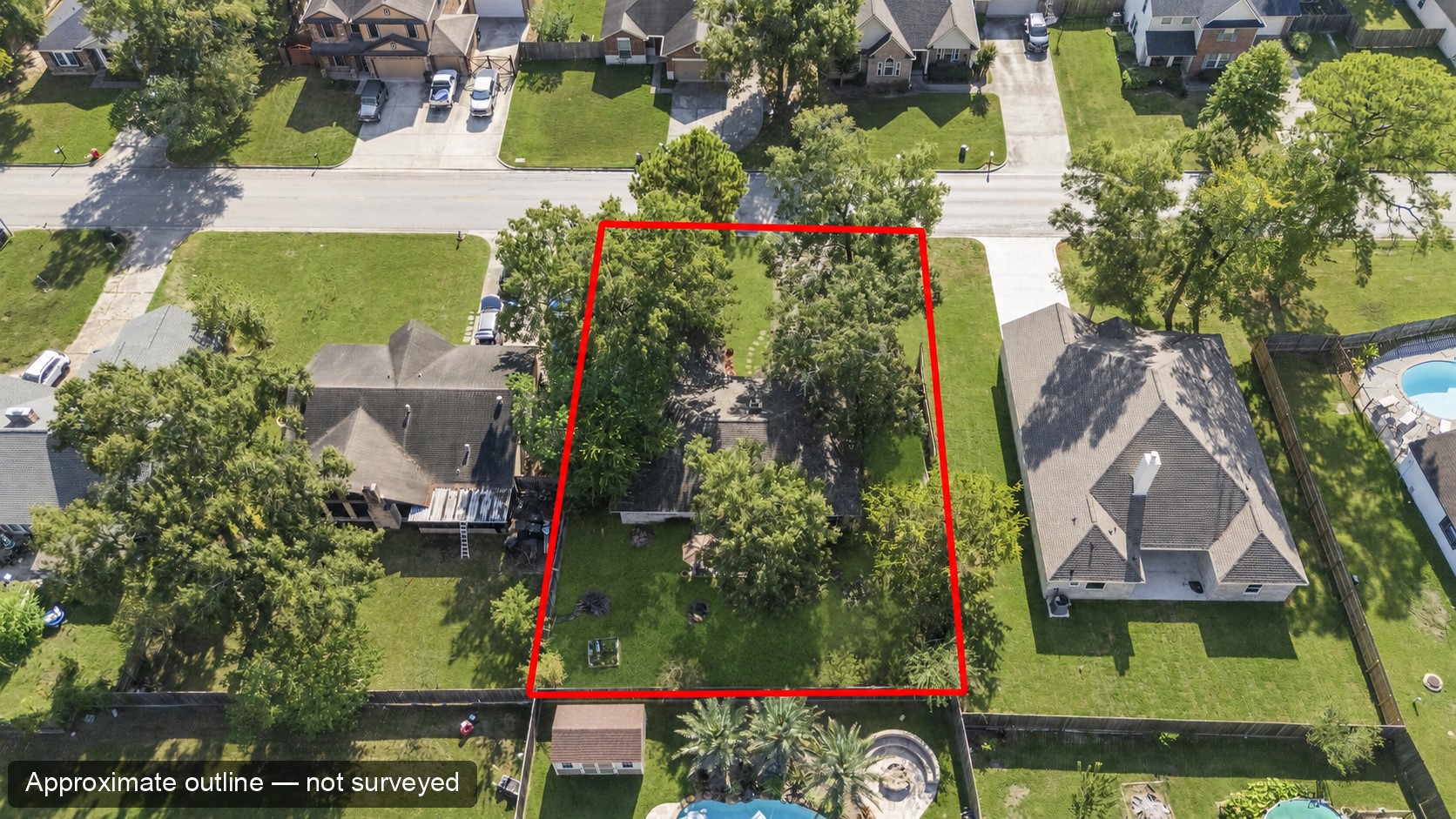 Overhead aerial of the home and surrounding properties. The red outline is approximate, for location only, and is not a surveyed boundary.