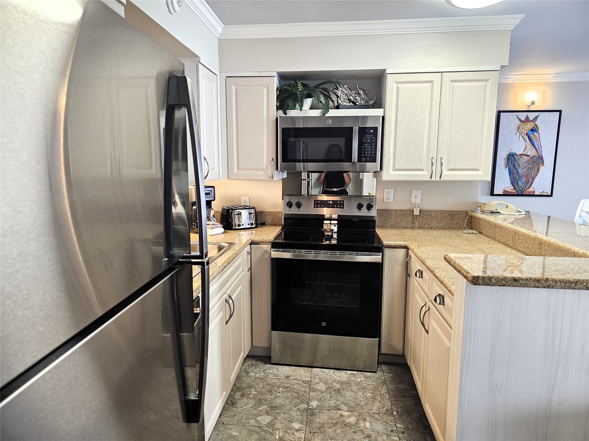 Modern kitchen with stainless steel appliances, sleek granite countertops, and ample cabinet space for storage.