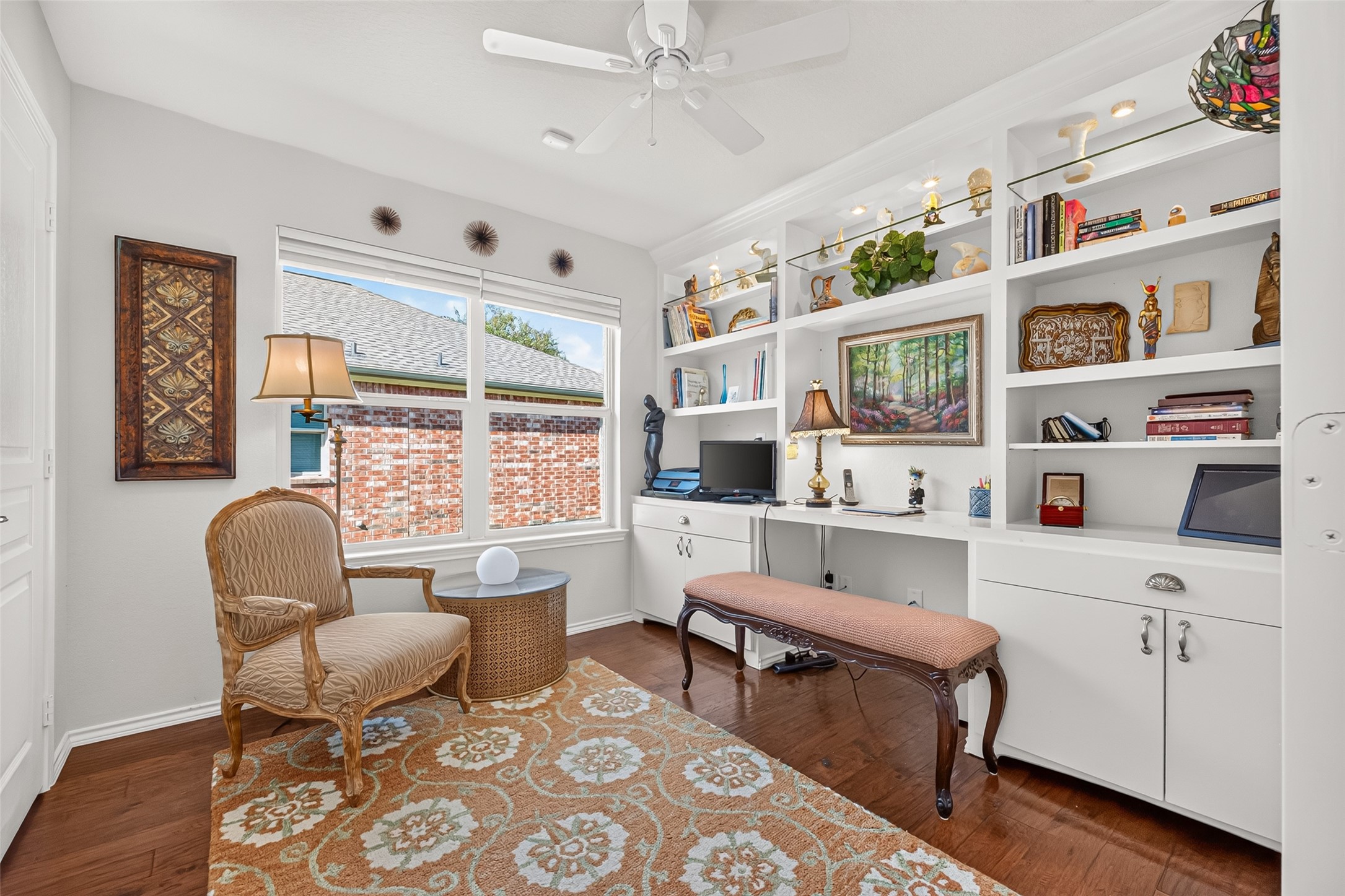 A welcoming home office with a built-in desk and abundant storage.