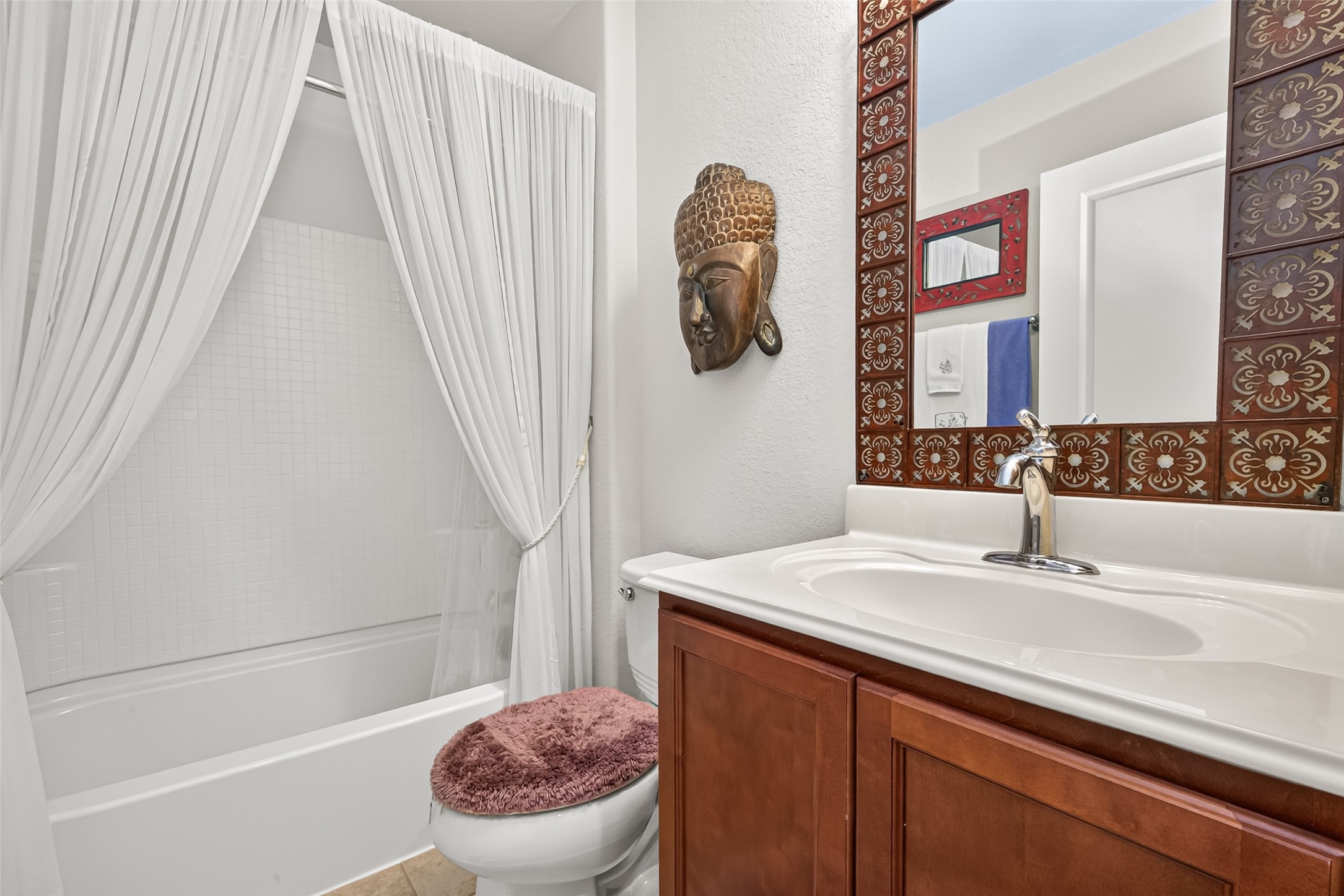A welcoming guest bathroom with a tub and shower combination.