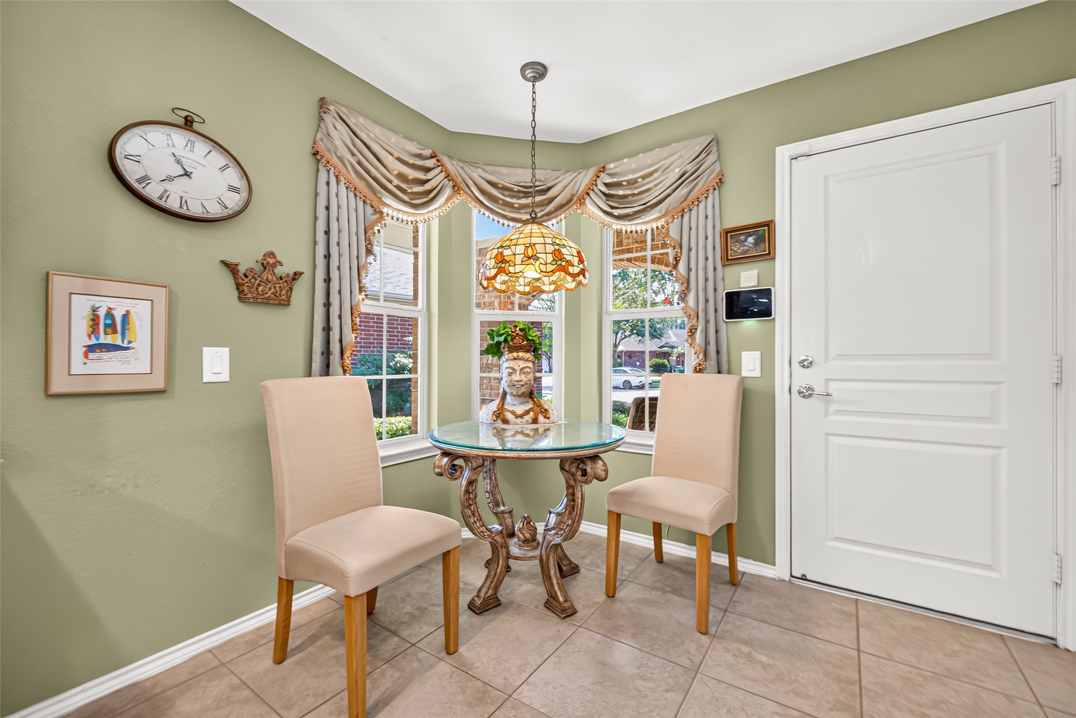 A sunny breakfast nook with beautiful custom stained glass.