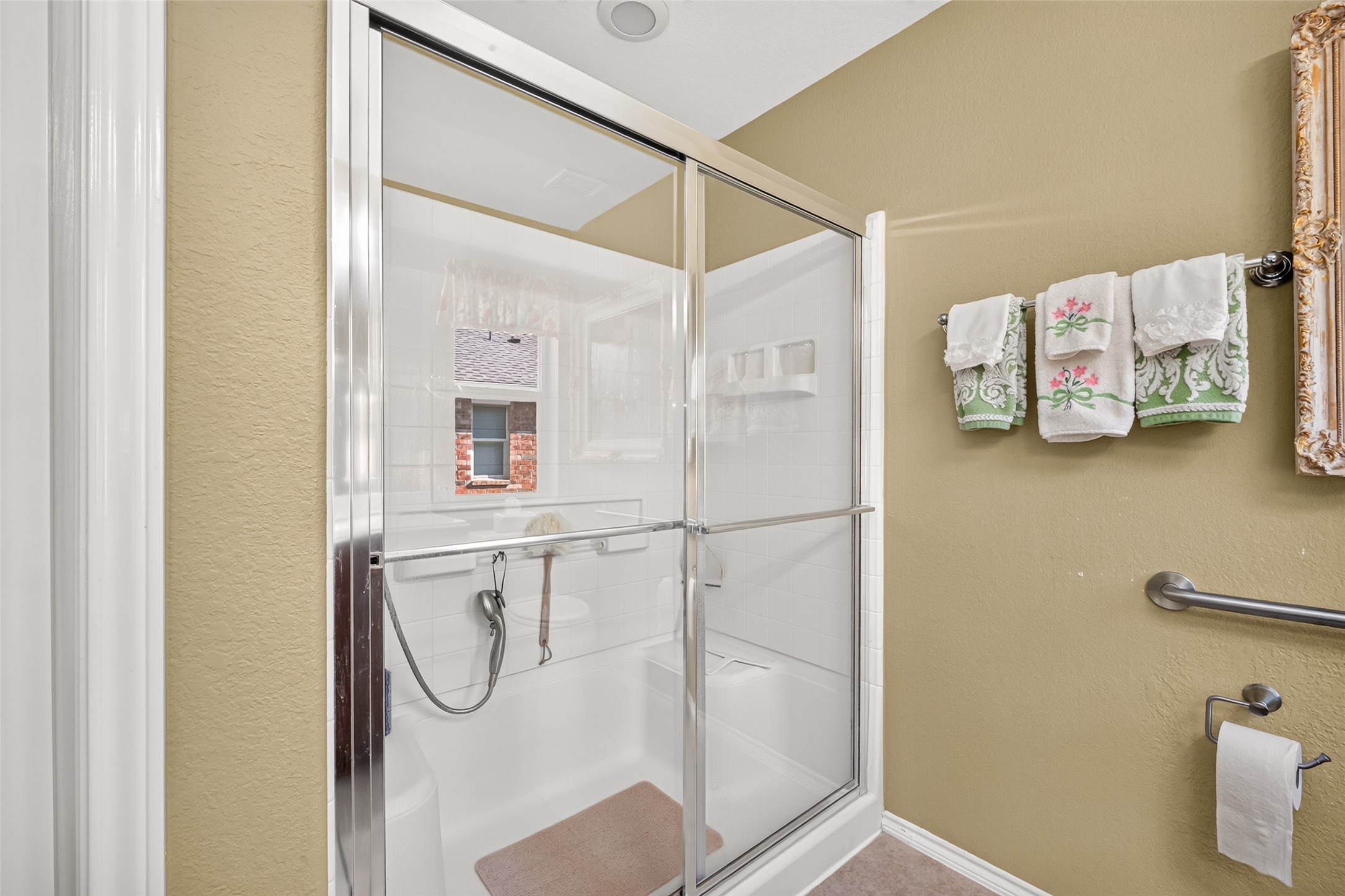 An extra-large walk-in shower offers a spacious setting to refresh.