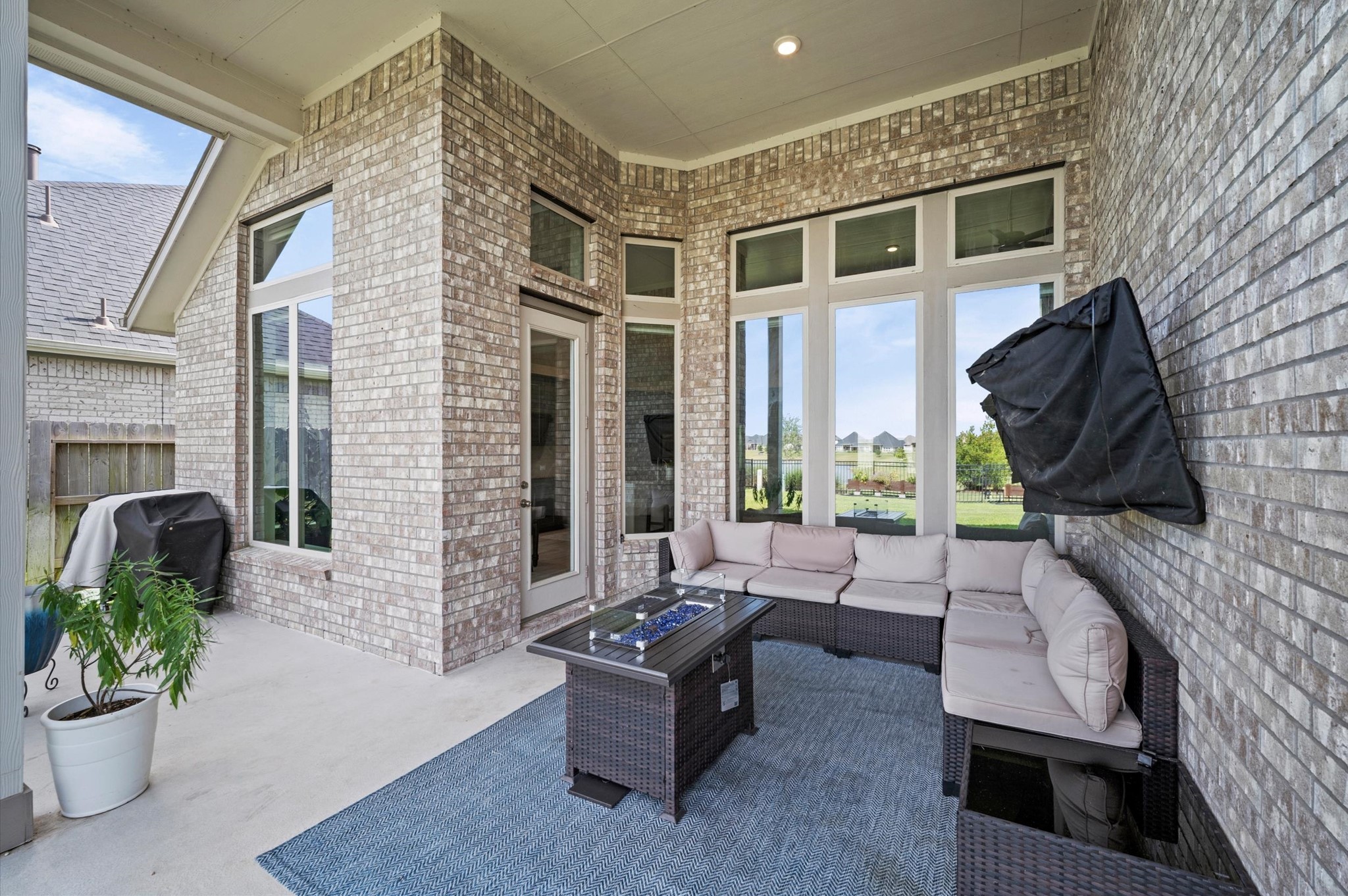 Charming covered patio with elegant brickwork, perfect for outdoor relaxation and entertainment.