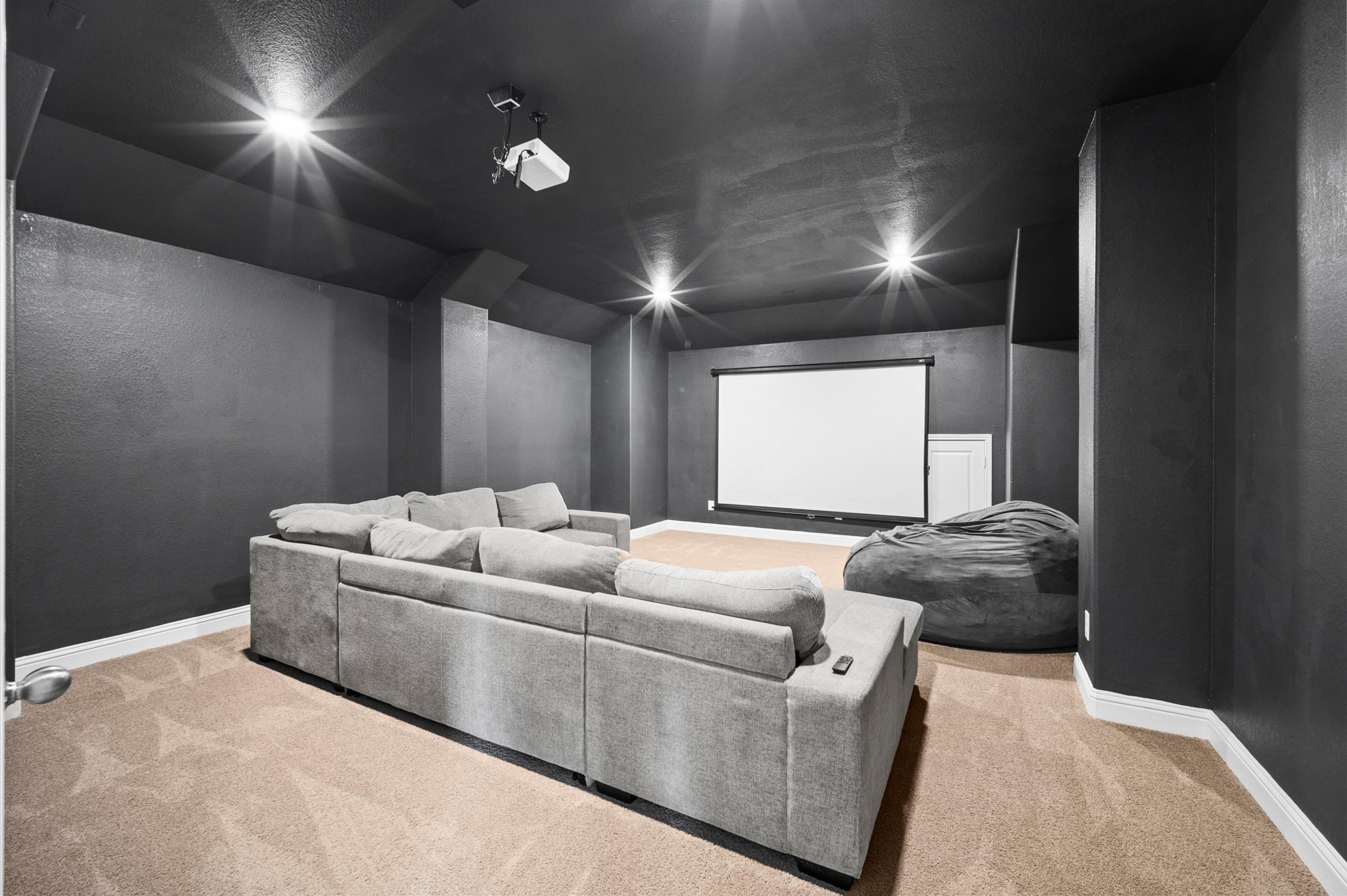 Oversized media room located off the top of the stairs.