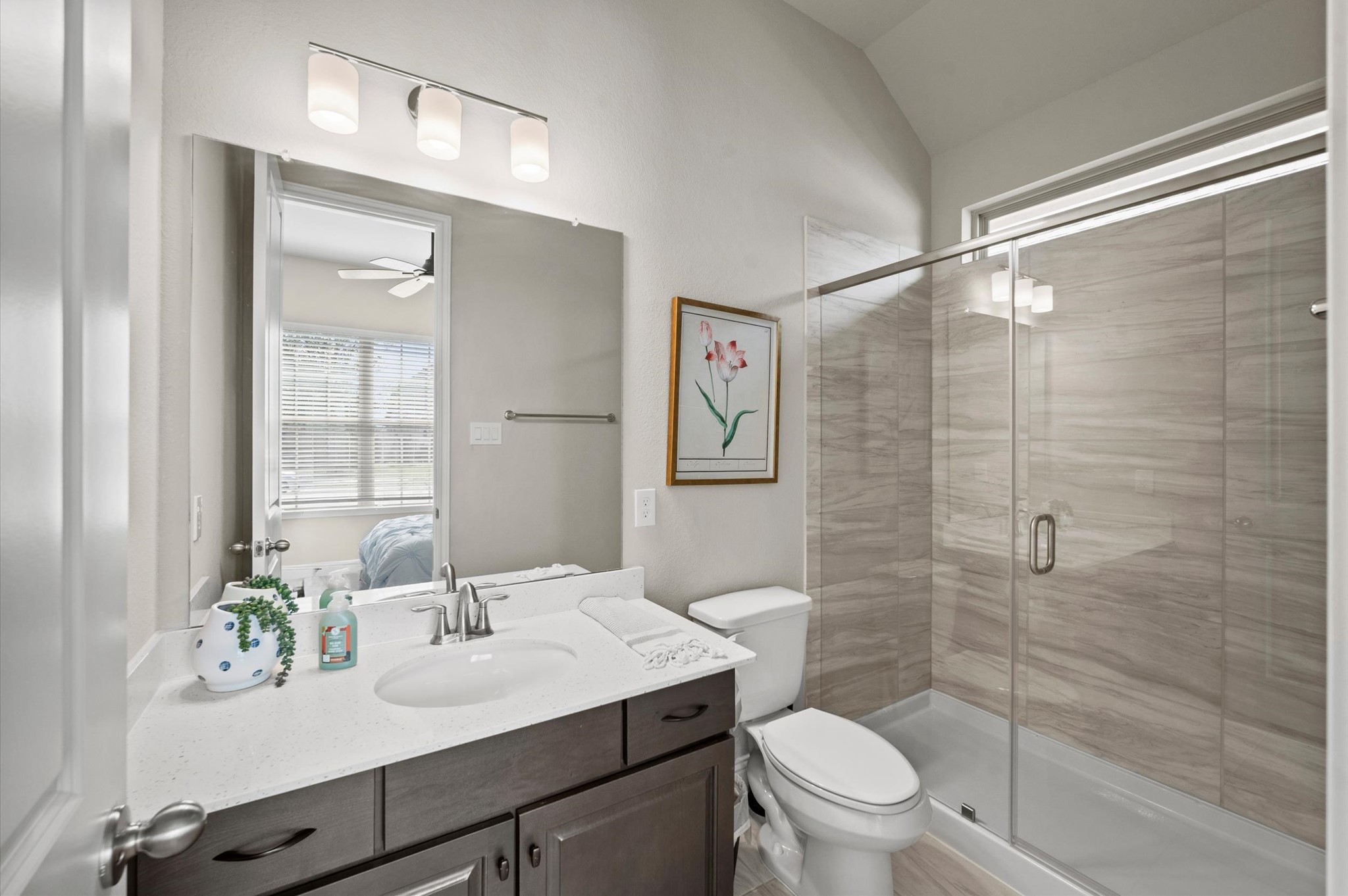 En suite bathroom featuring a spacious glass-enclosed shower, perfect for overnight guests.