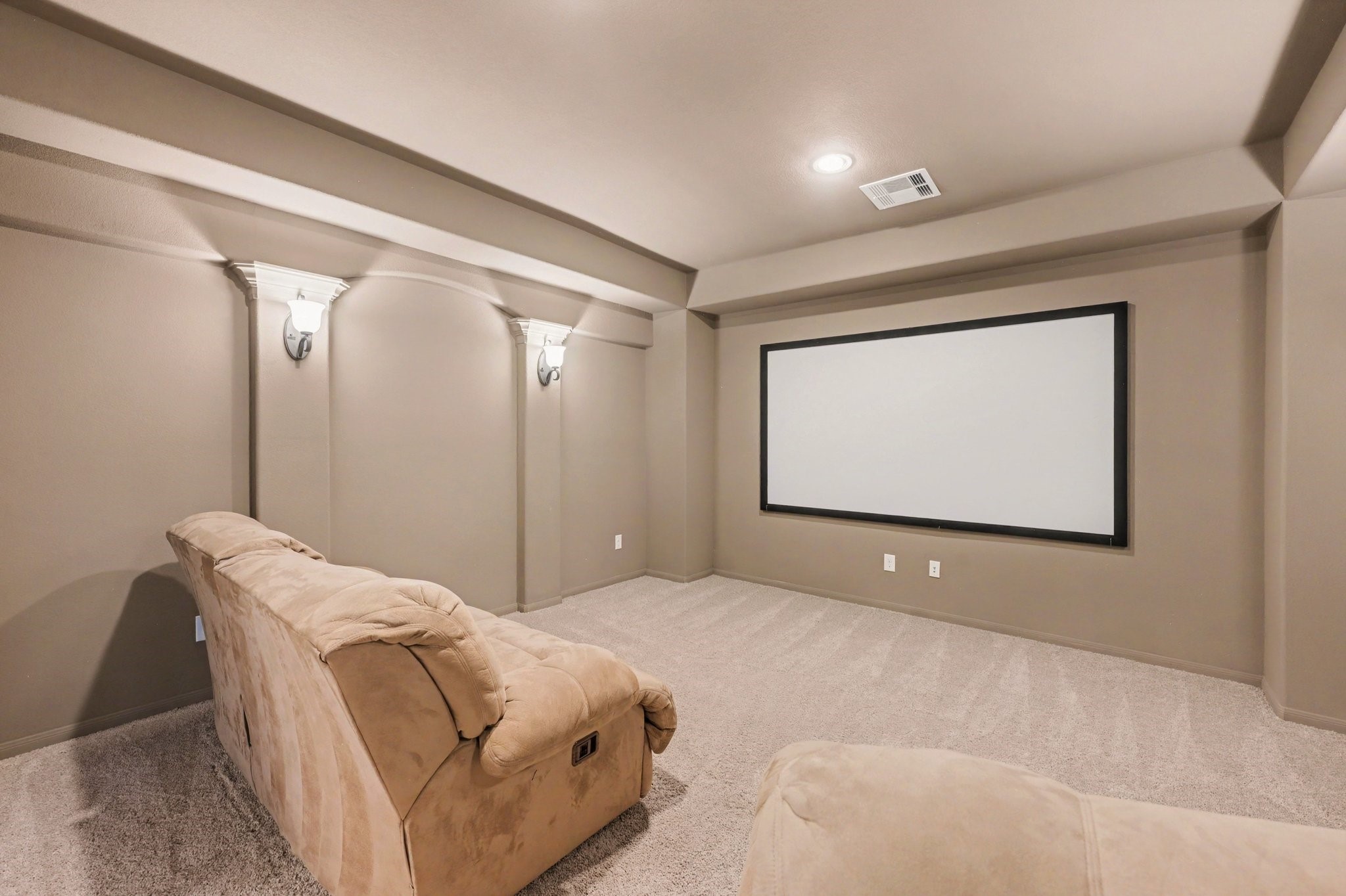 Dedicated upstairs media room with a large projection screen, perfect for movie nights and entertainment.