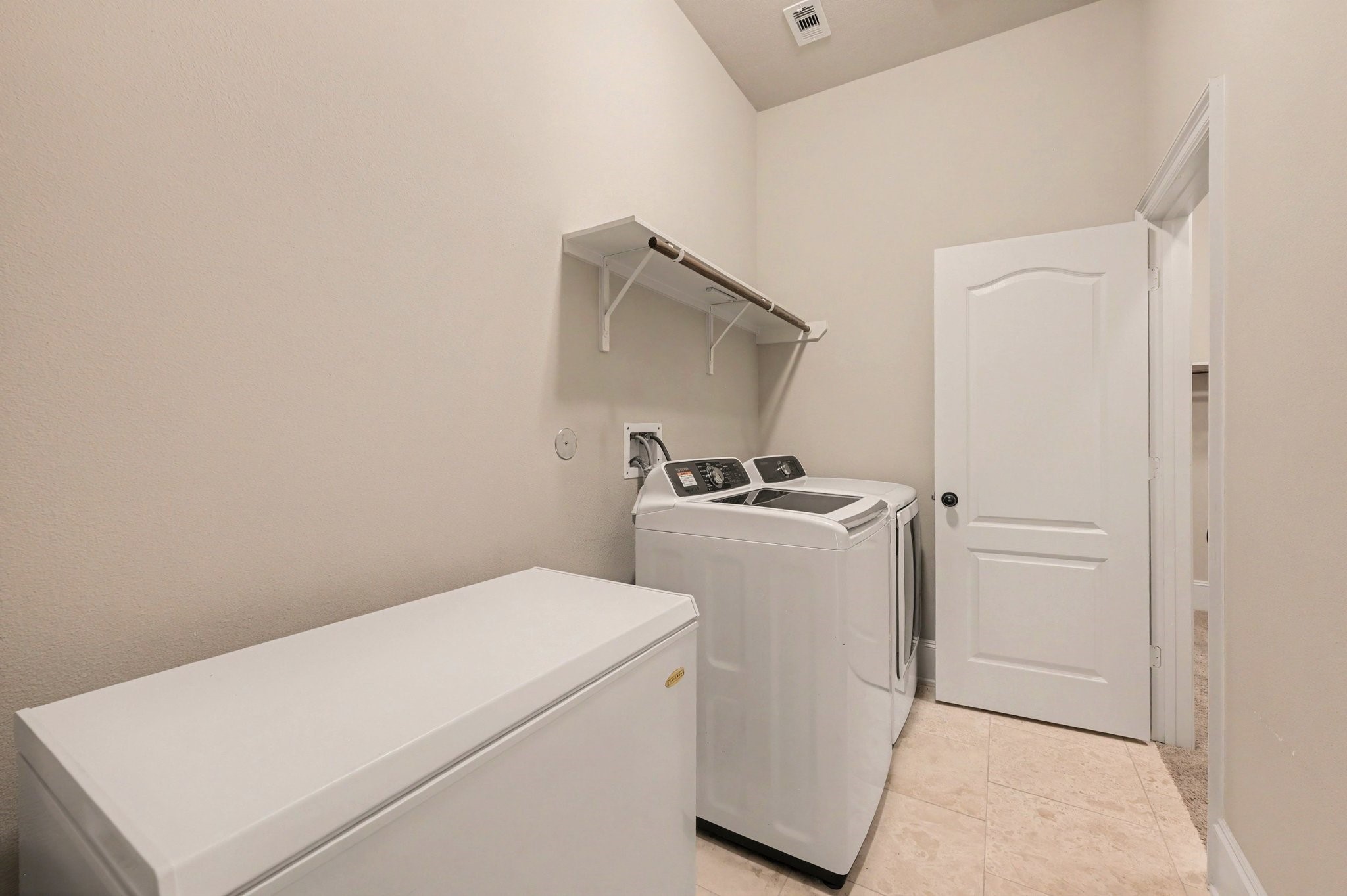 The downstairs laundry room has direct access to the enormous primary walk-in closet